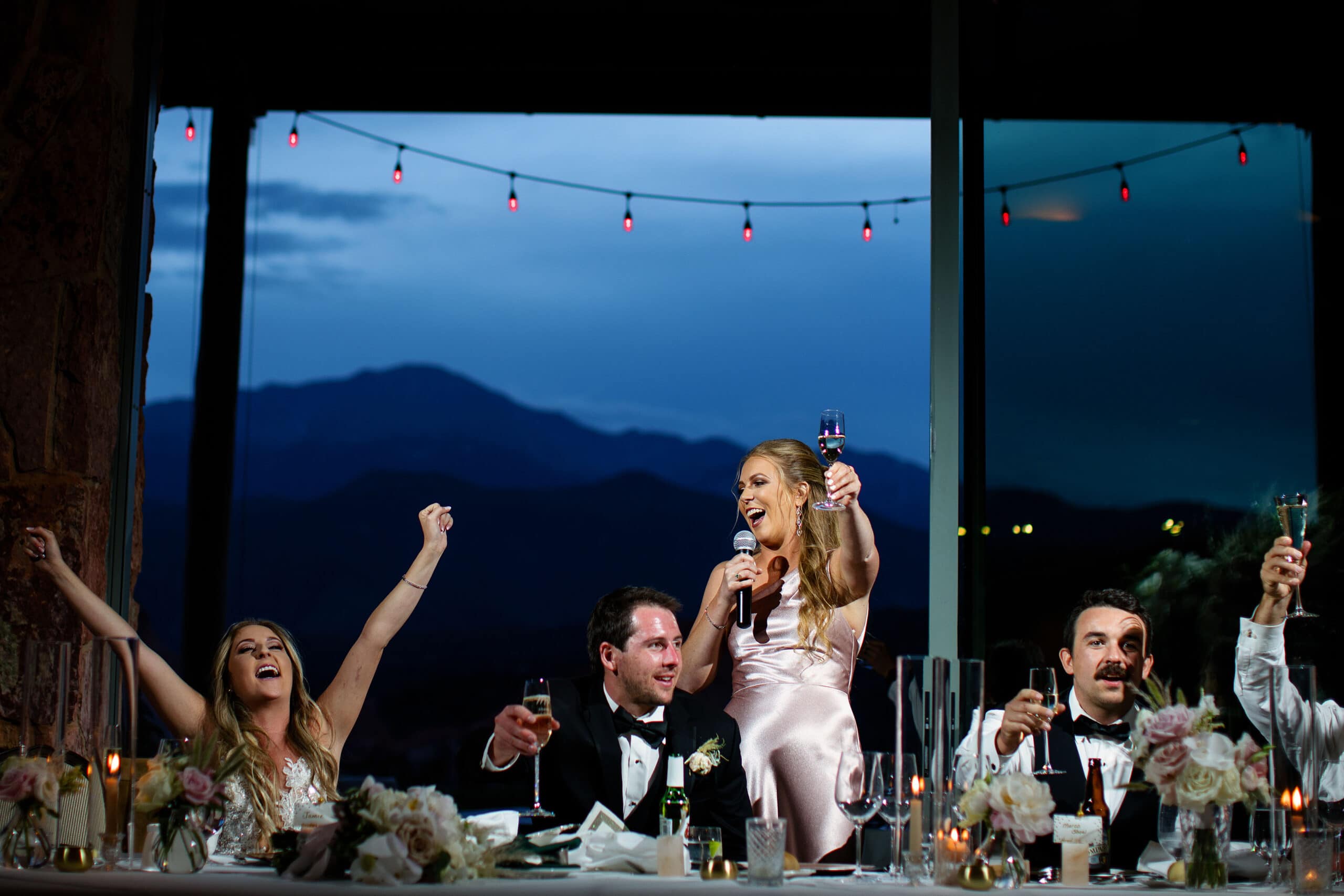 The maid of honor gives a toast as the bride reacts during the wedding reception at Garden of the Gods Resort