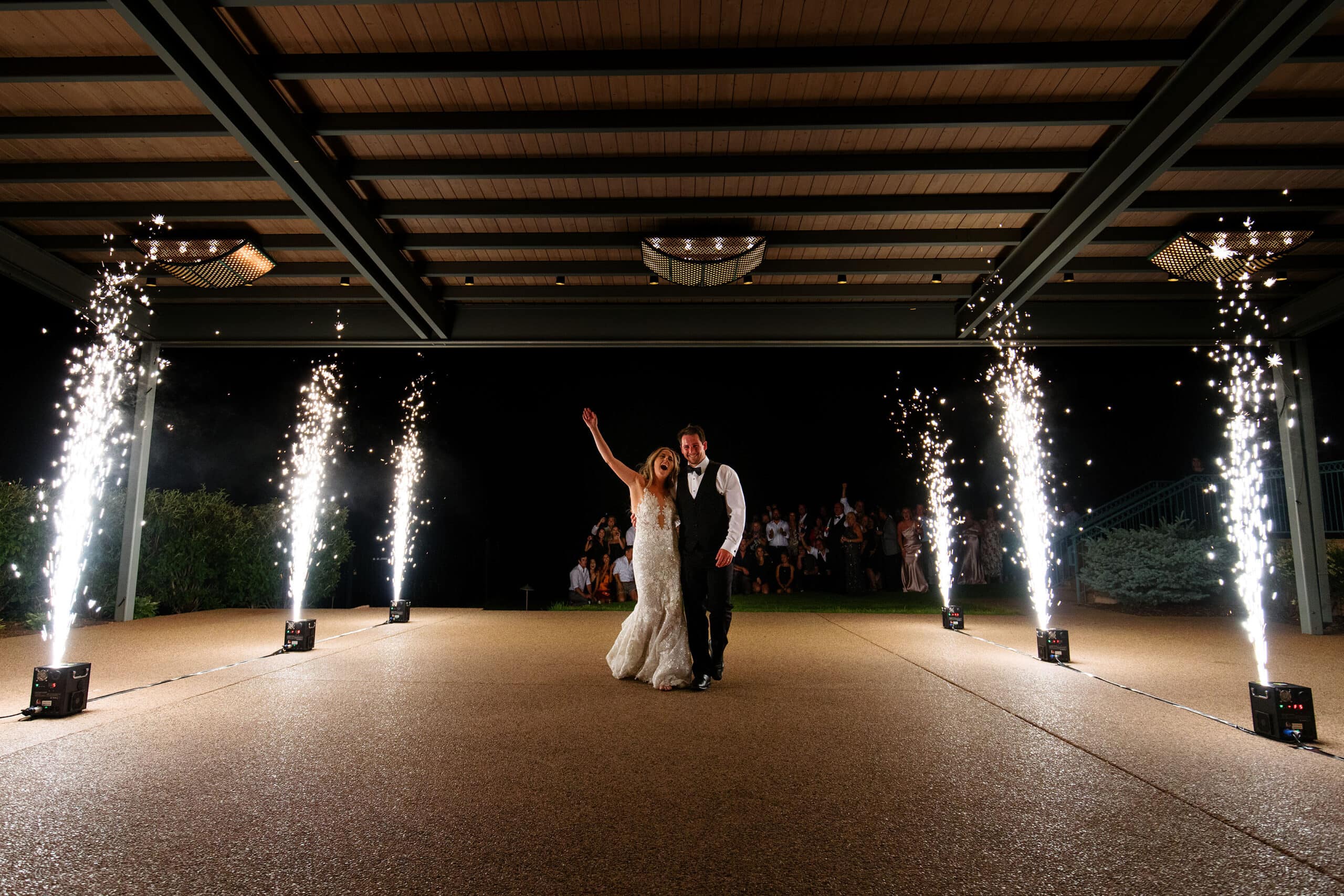 The bride and groom exit their wedding as fireworks go off at Garden of the Gods resort