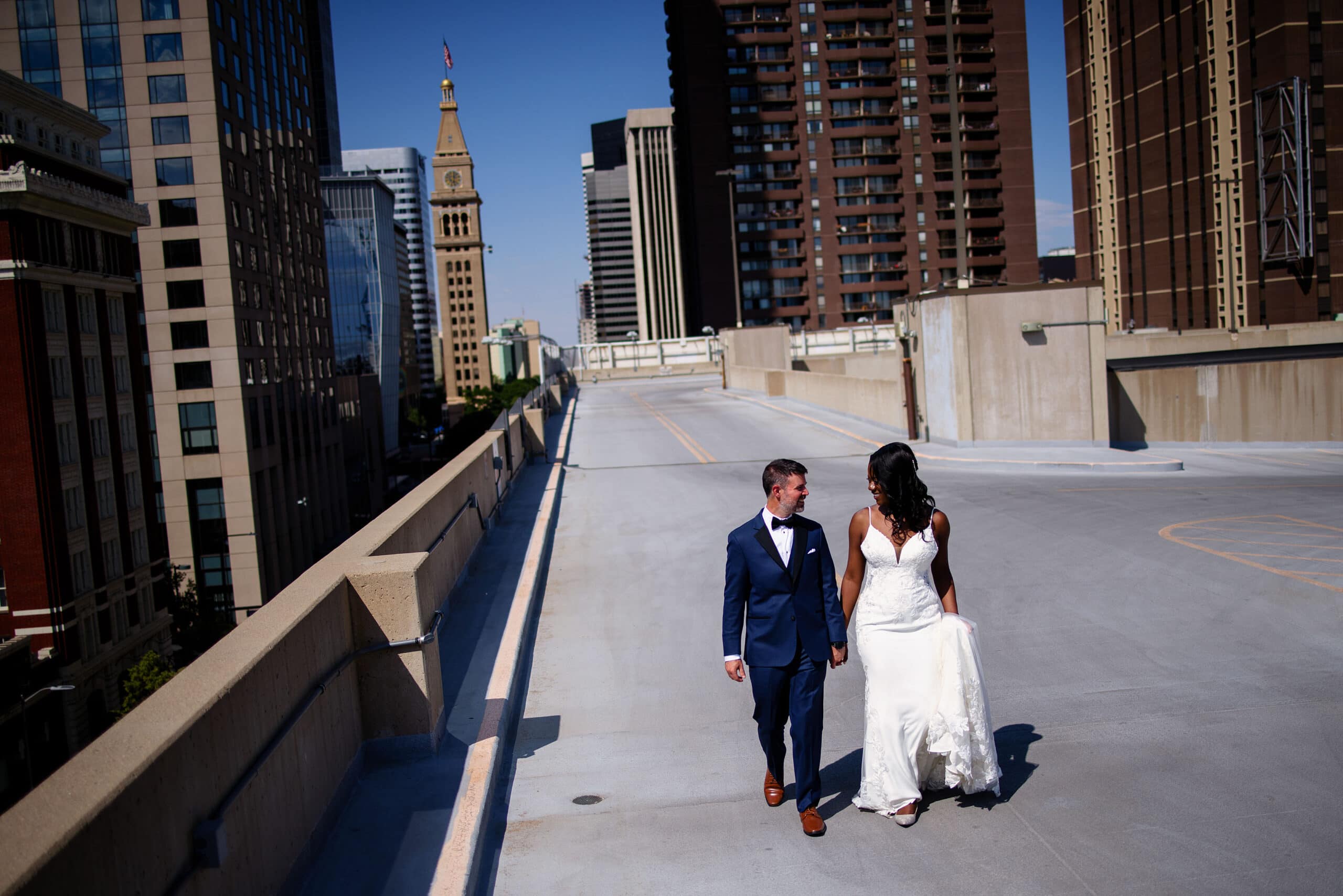 The newlyweds walk on the roof of a parking garage in Denver