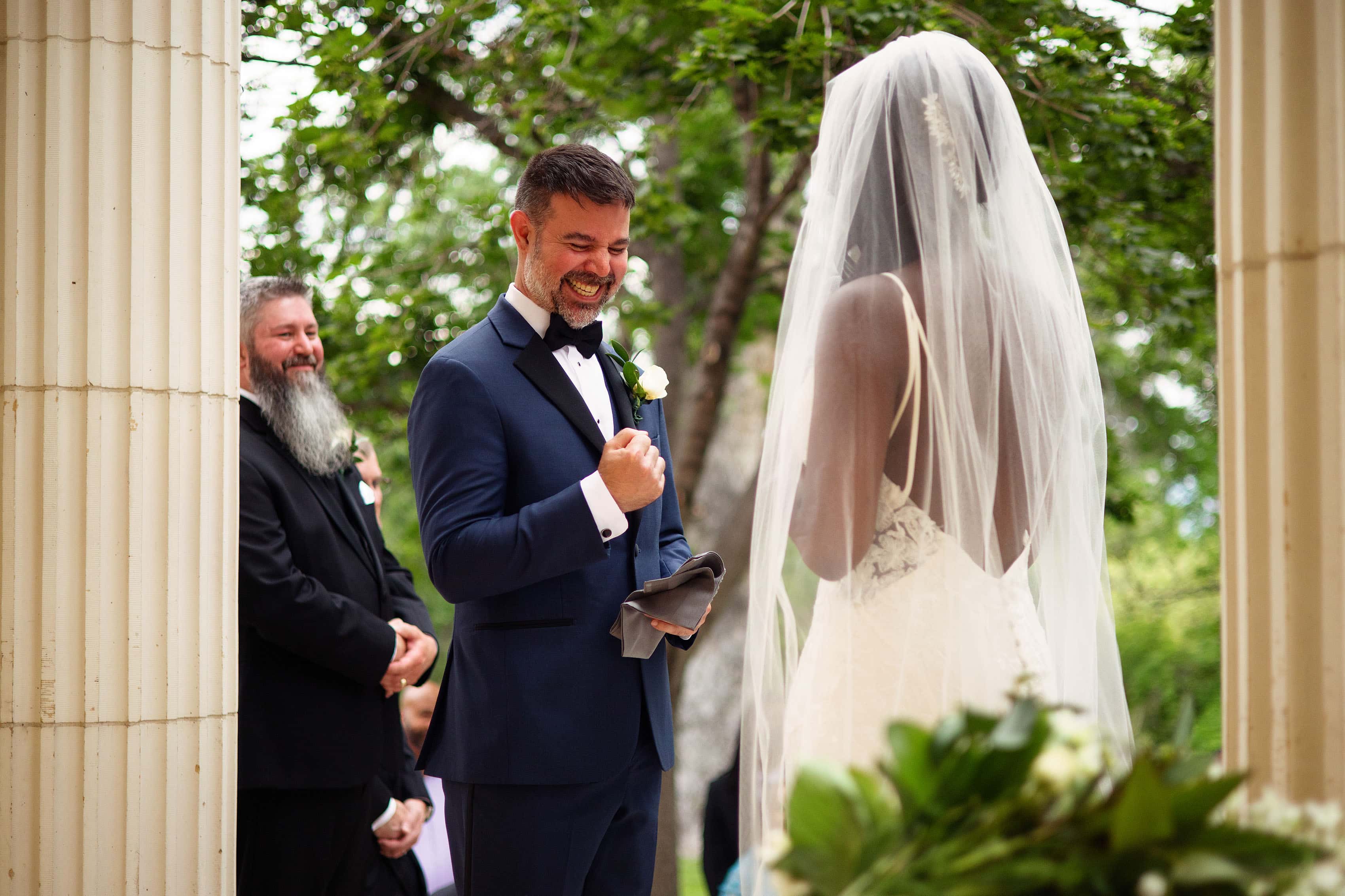 The groom reacts during the ceremony