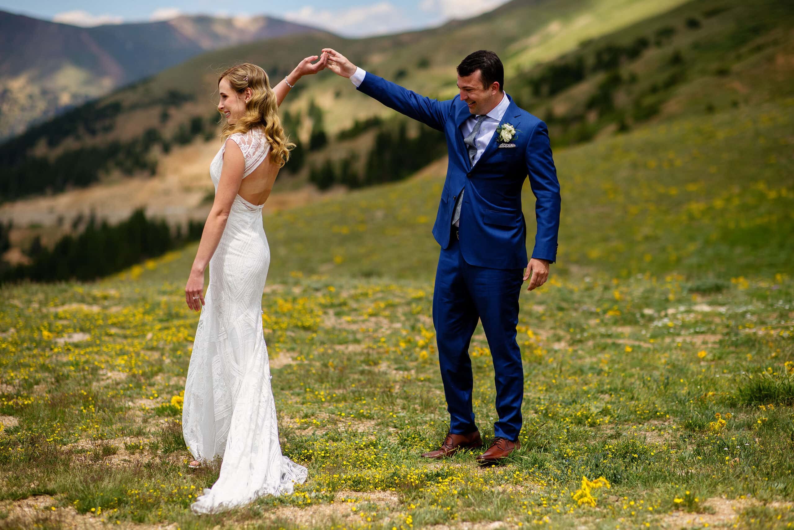 The groom spins the bride around on Lovelans Pass during their first look