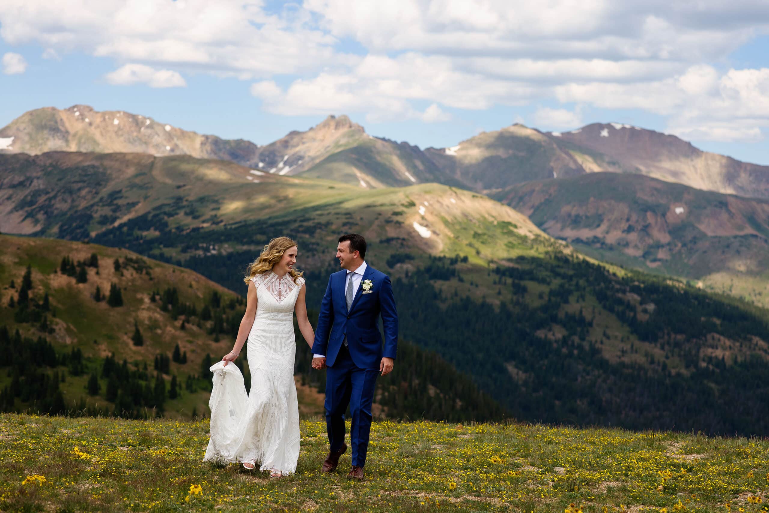 The bride and groom walk together on Loveland Pass