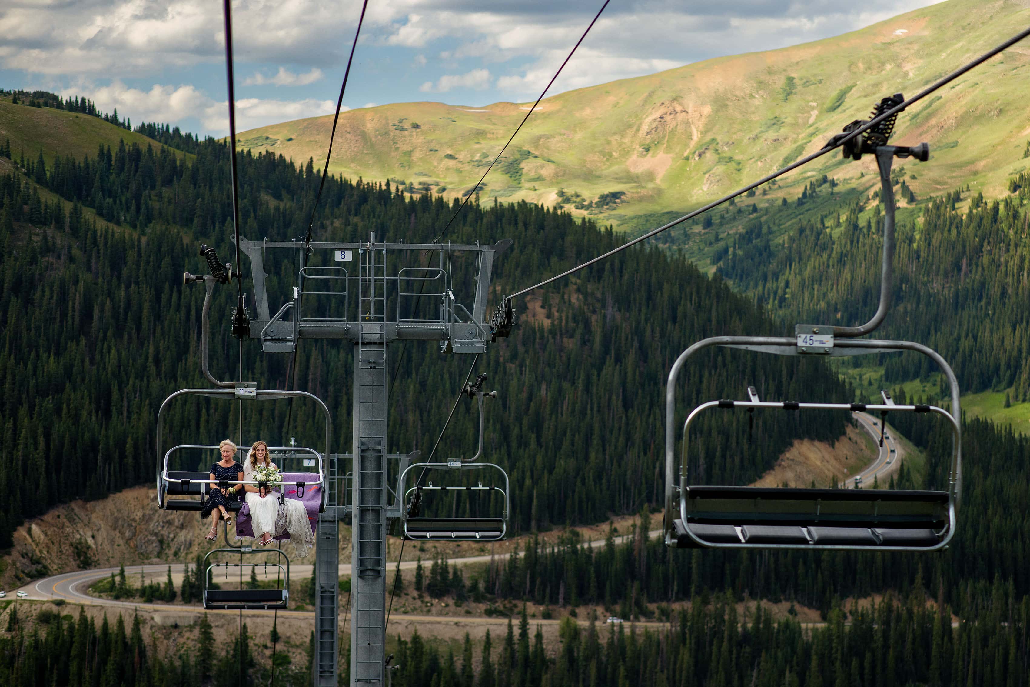 The bride rides the Black Mountain Express chairlift with her mother to the ceremony