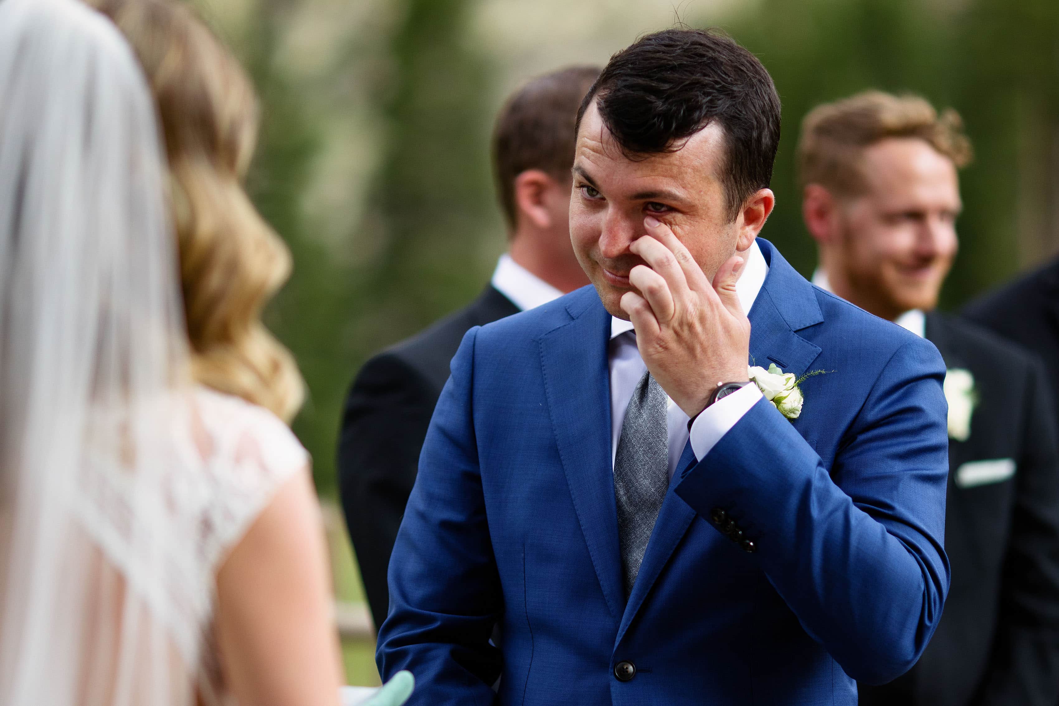 The groom wipes away a tear during the ceremony