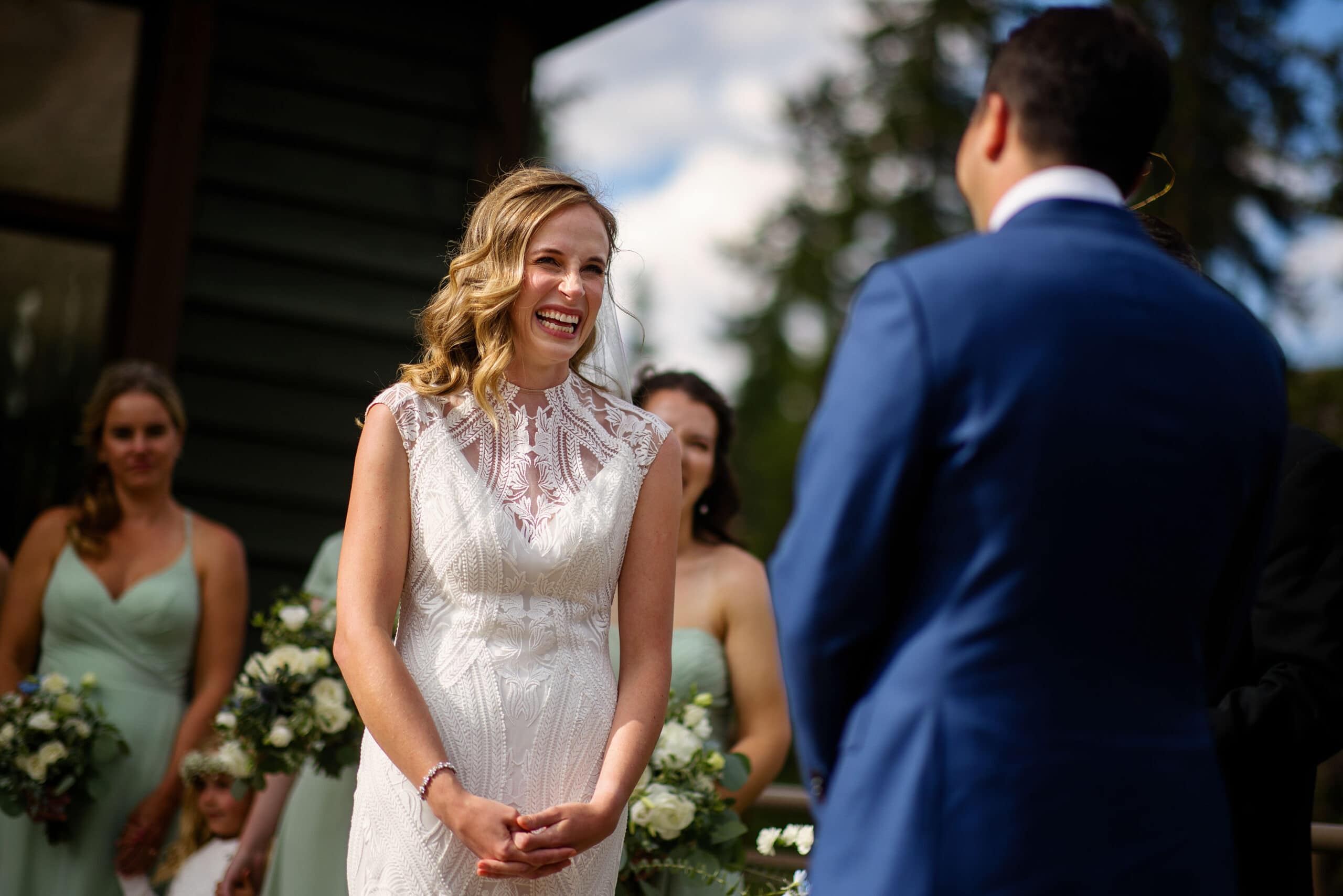 The bride laughs with the groom during the ceremony