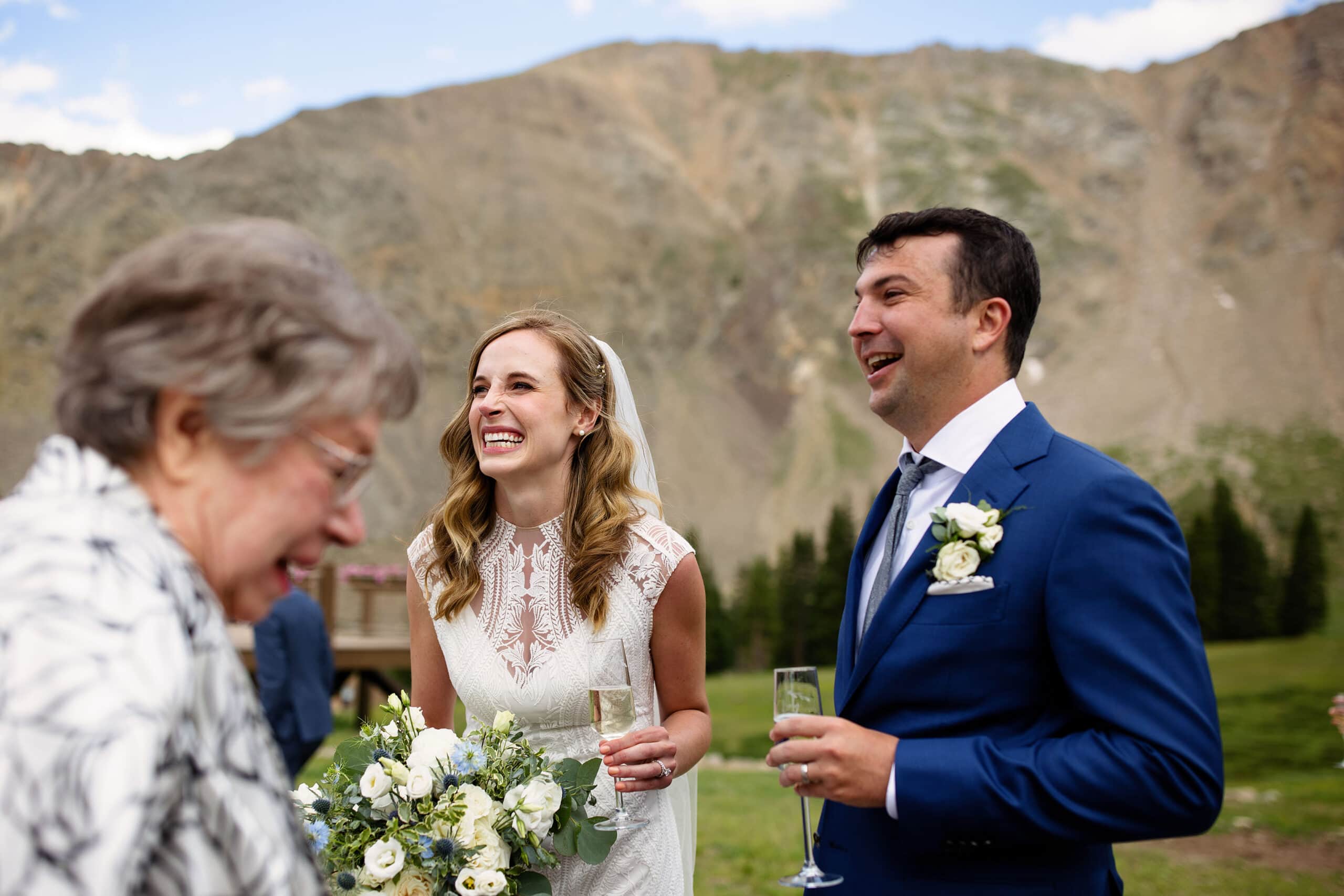The bride and groom share a laugh with her grandmother