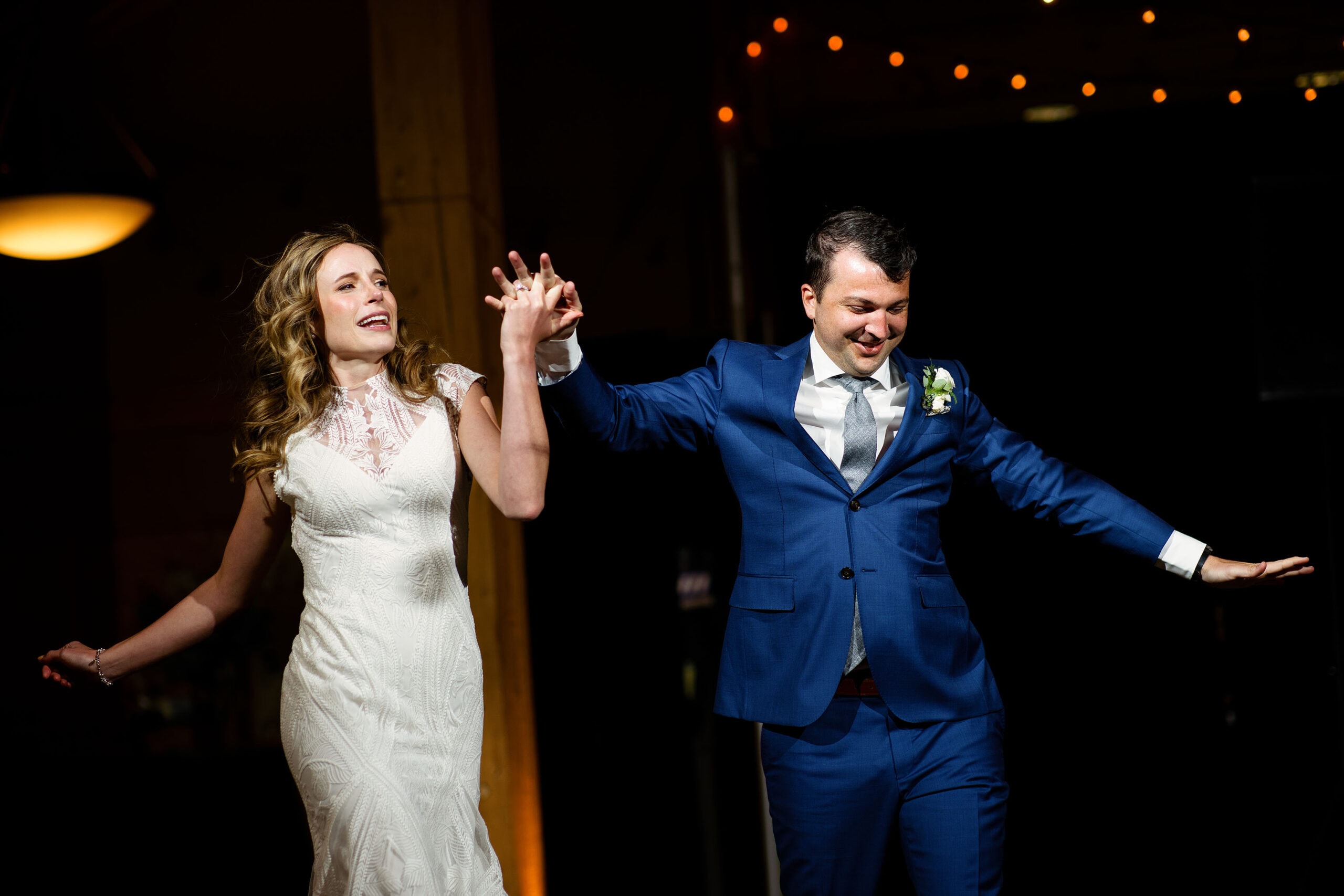 The newlyweds dance while introduced to their reception