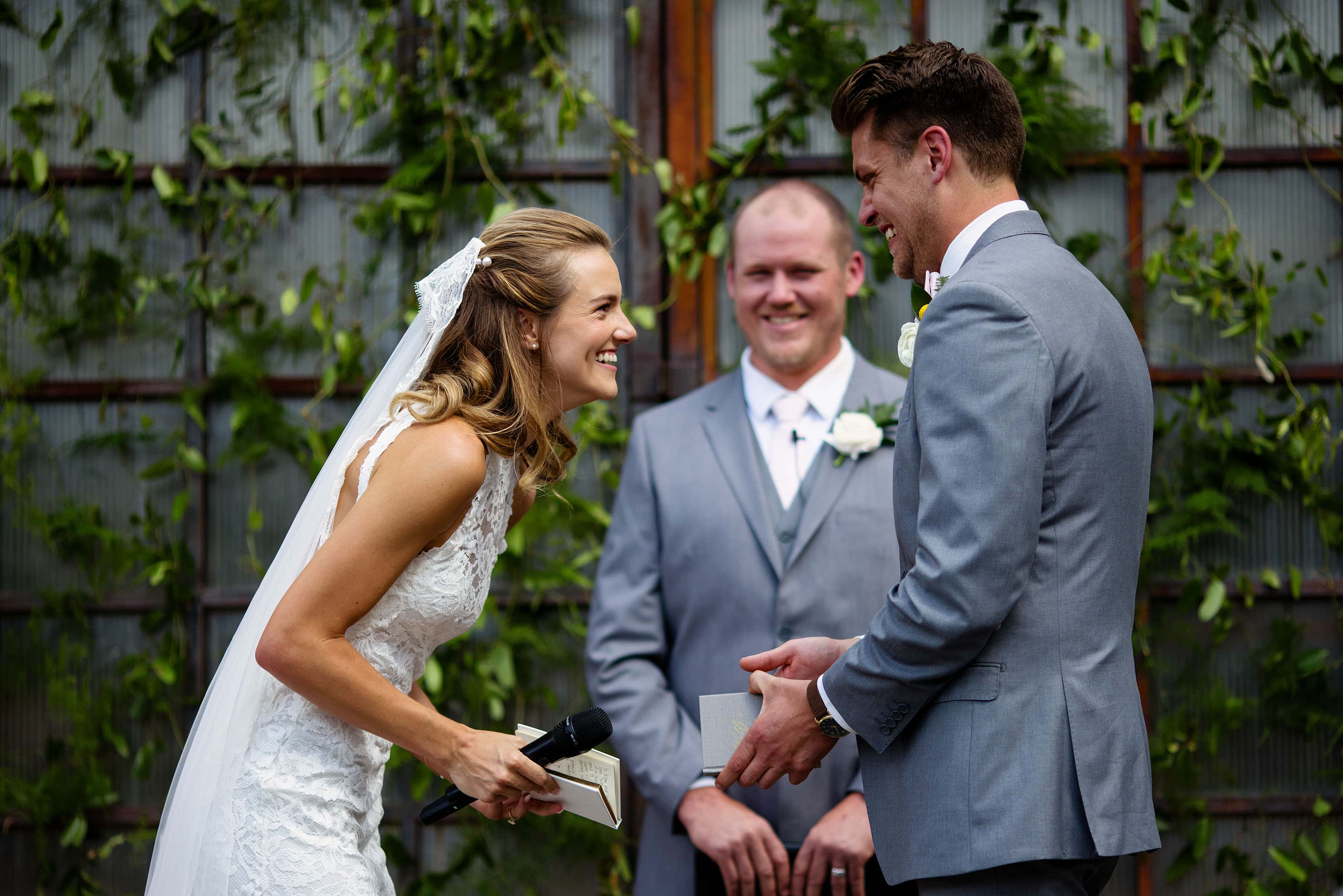 The bride and groom laugh together during their vows