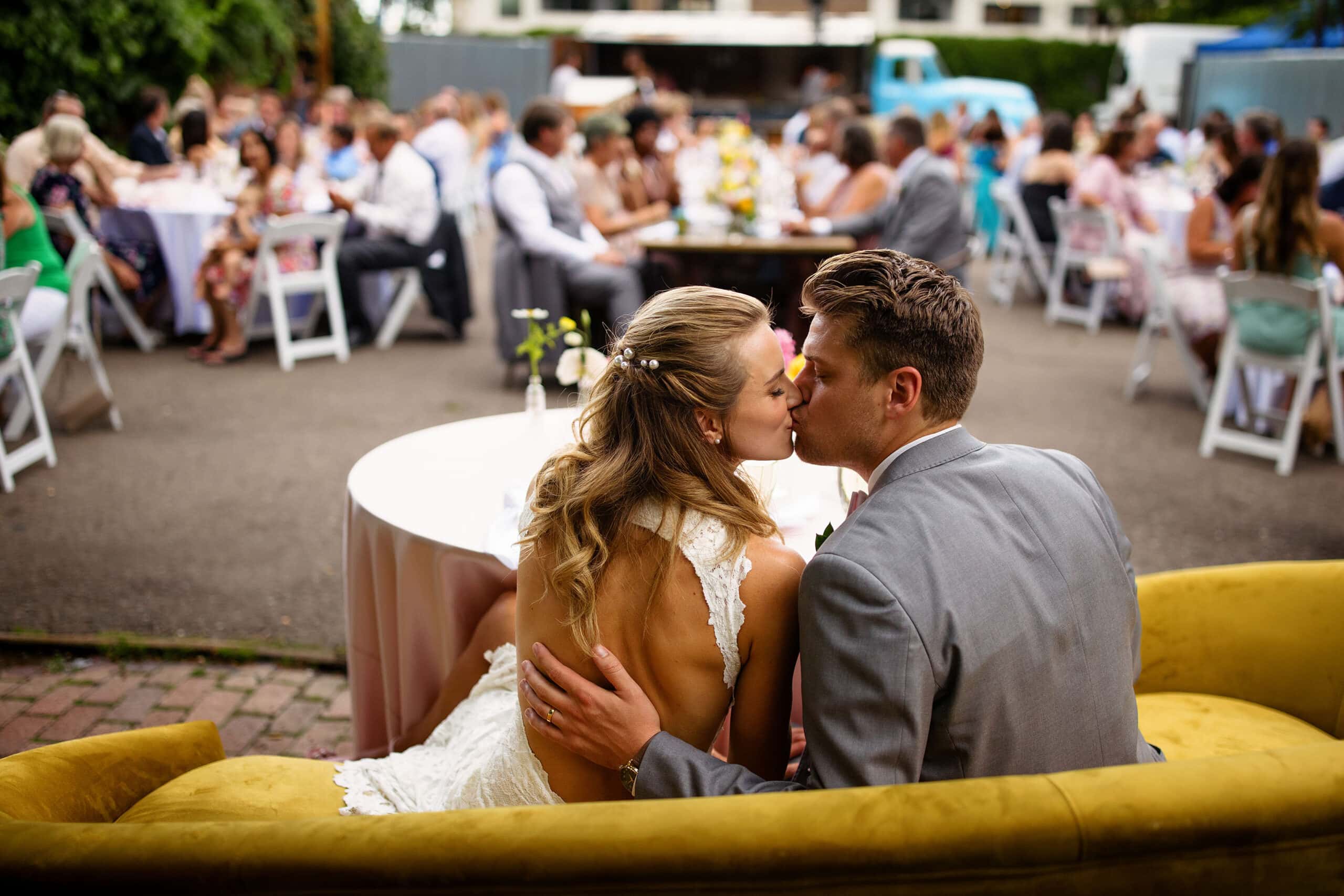 The newlyweds share a kiss from their sweetheart table during the reception
