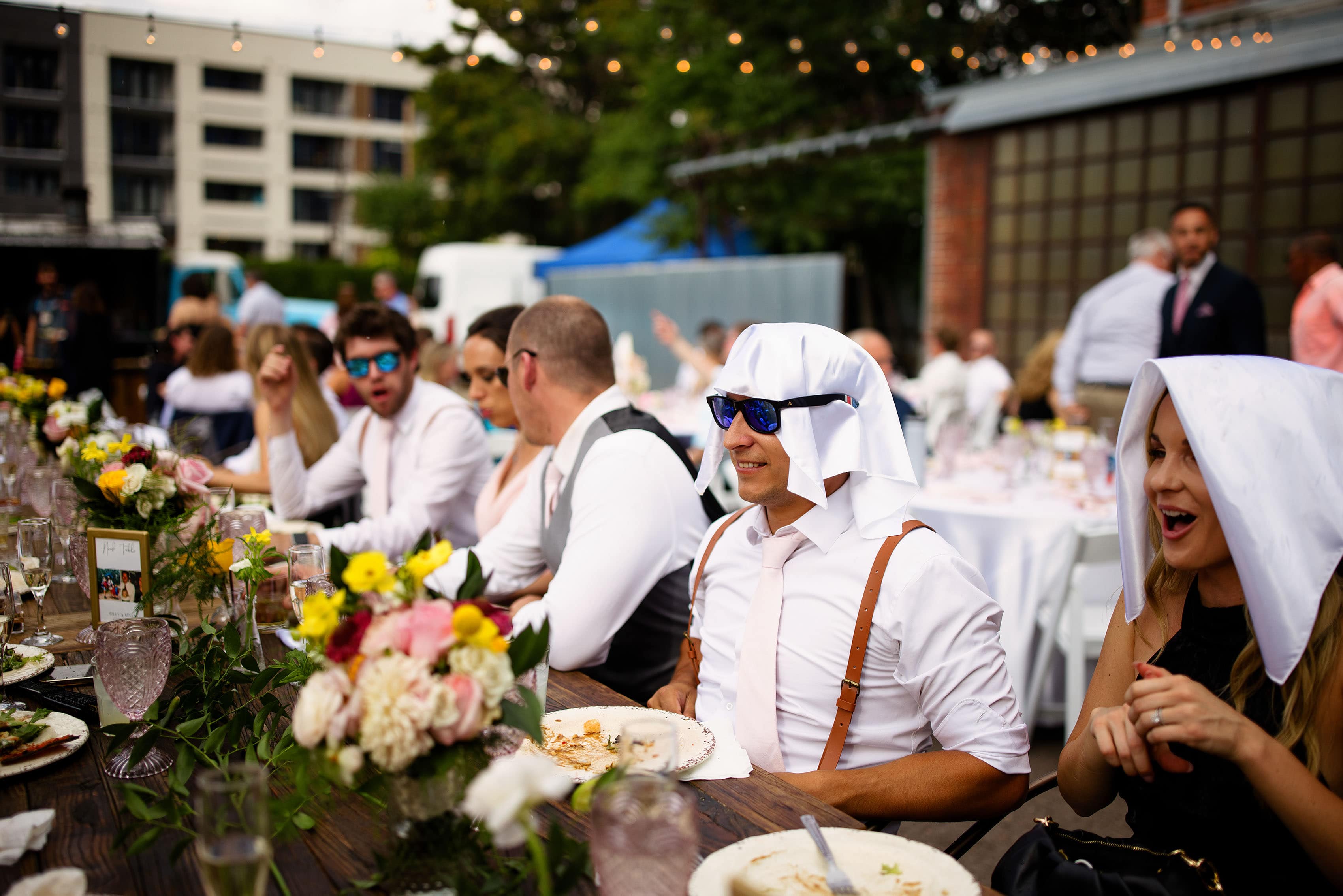Guests use napkins to shade themselves during dinner