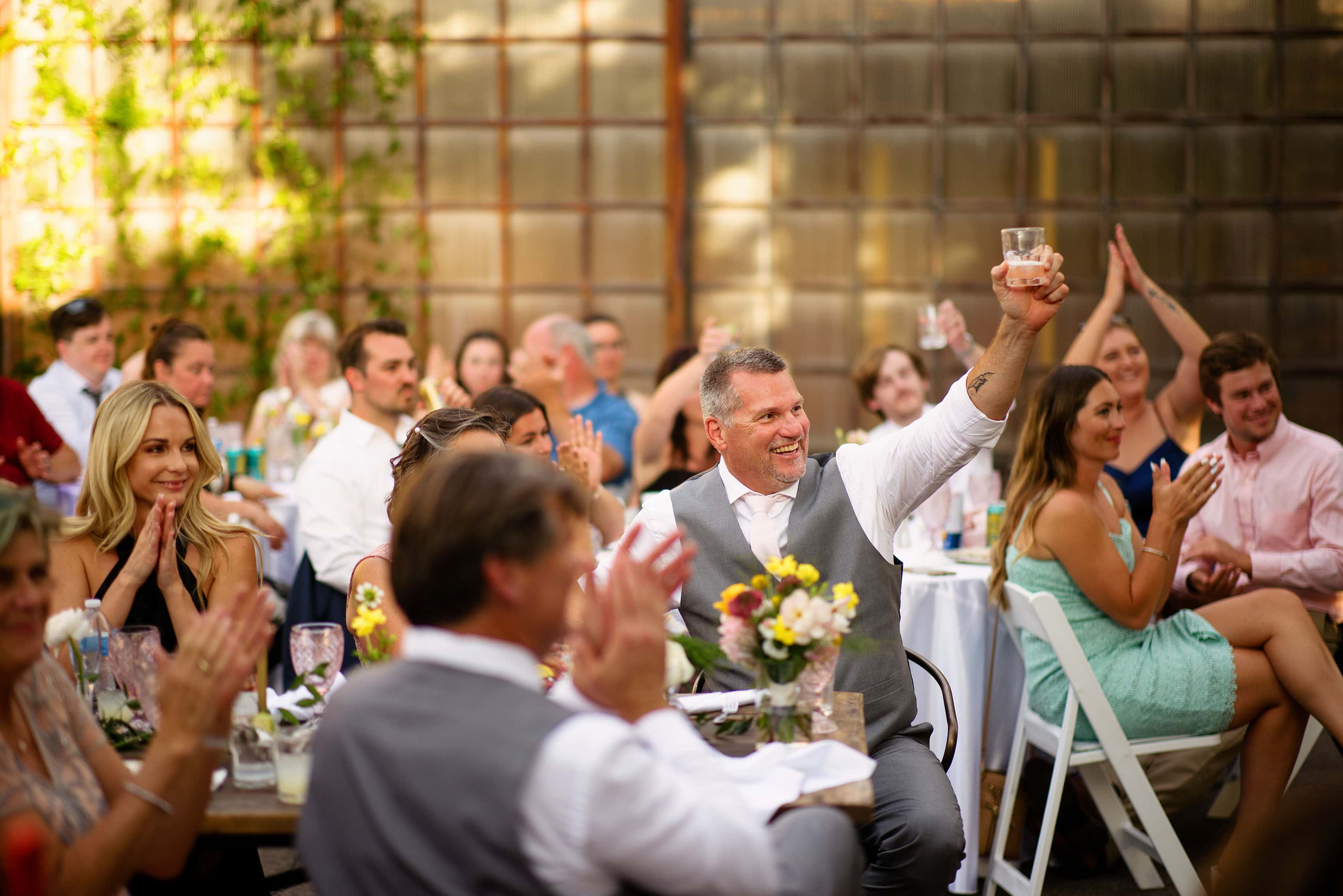 Guests react during toasts at Blanc in Denver