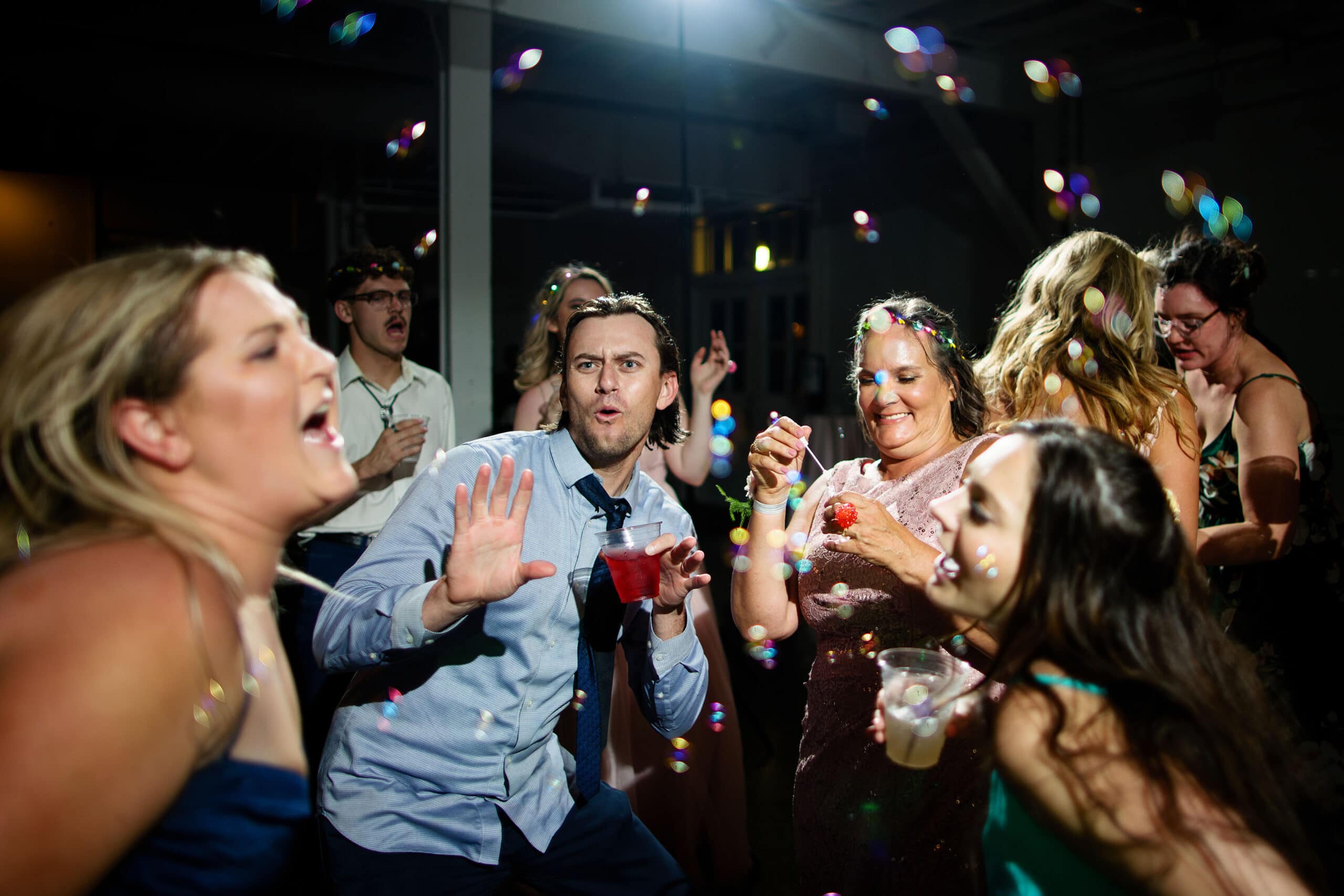 Guests dancand blow bubbles during a wedding reception at Blanc in Denver