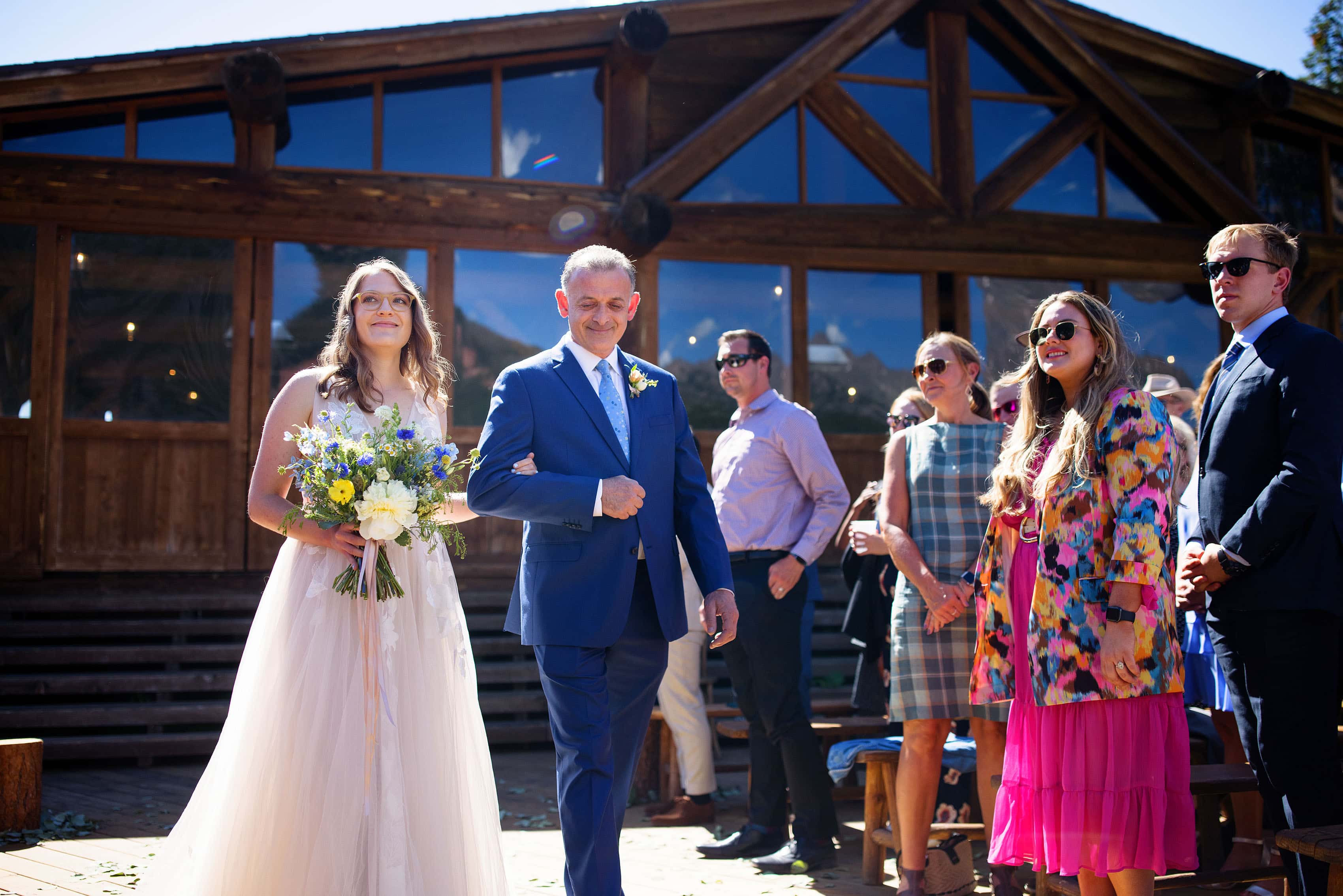 Alice and her father walk down the aisle at Piney River Ranch