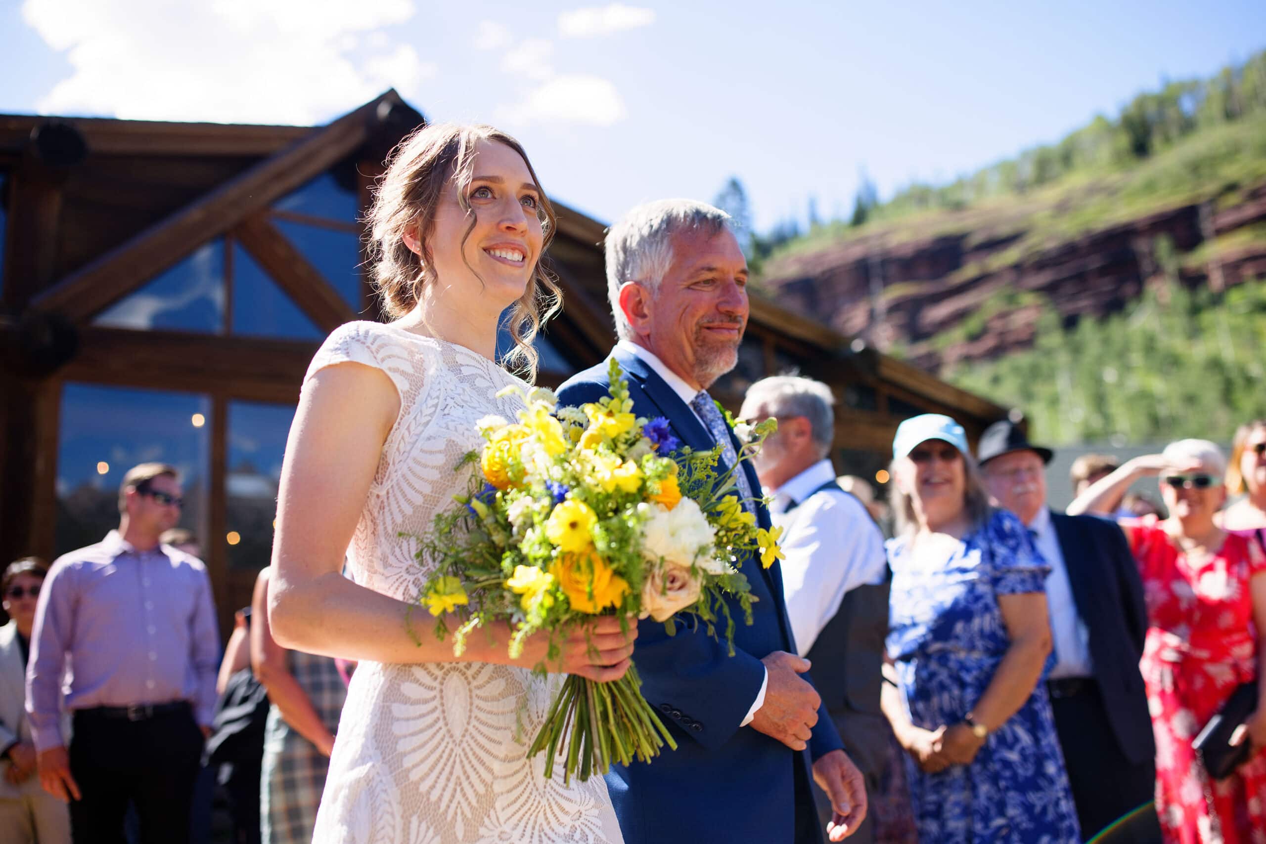 Miranda and her father walk down the aisle at Piney River Ranch