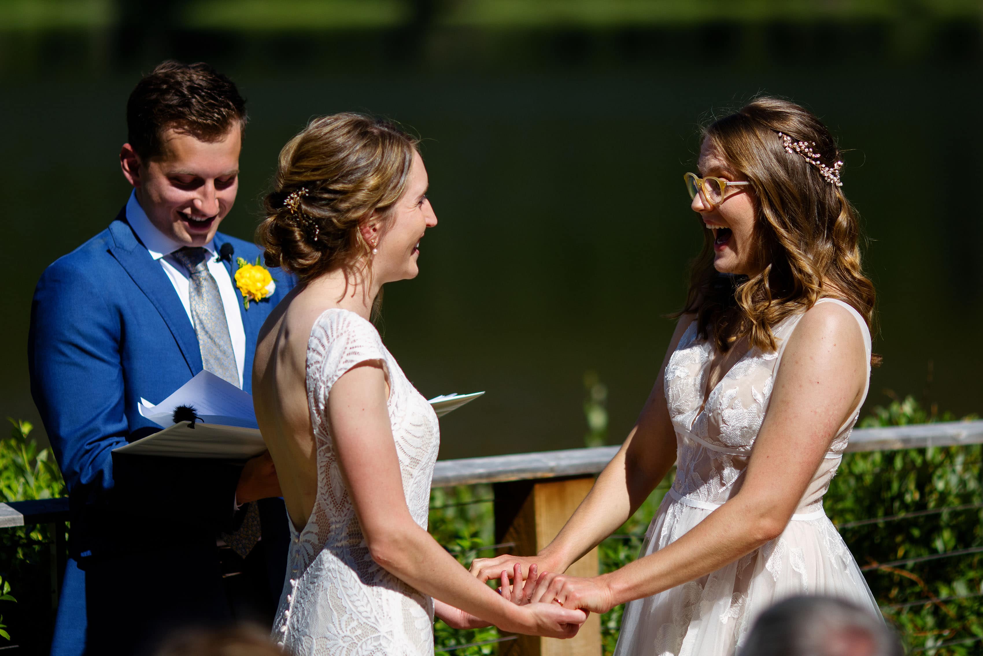 The brides react during the ceremony together