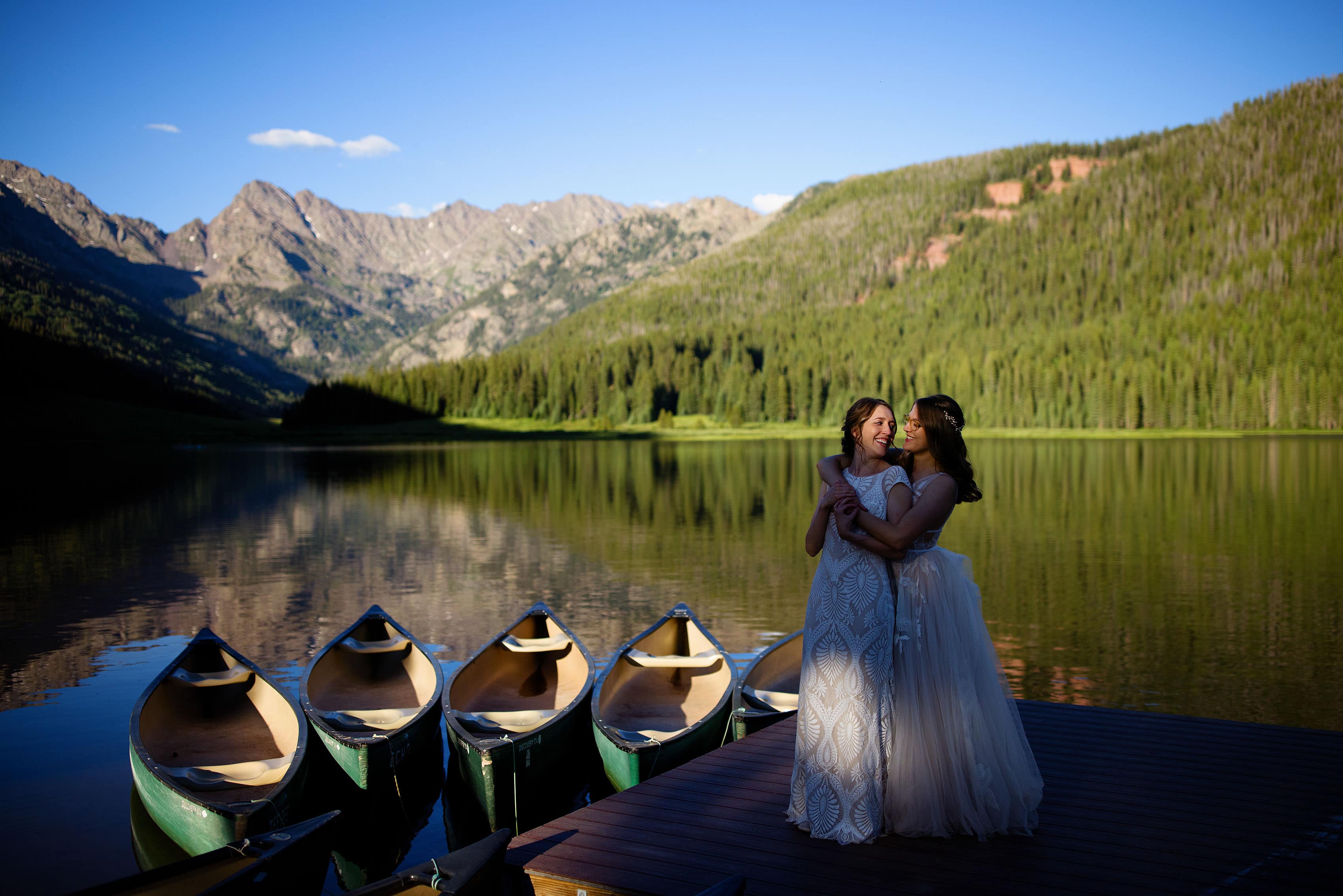 Miranda and Alice embrace on the boat dock at Piney River Ranch