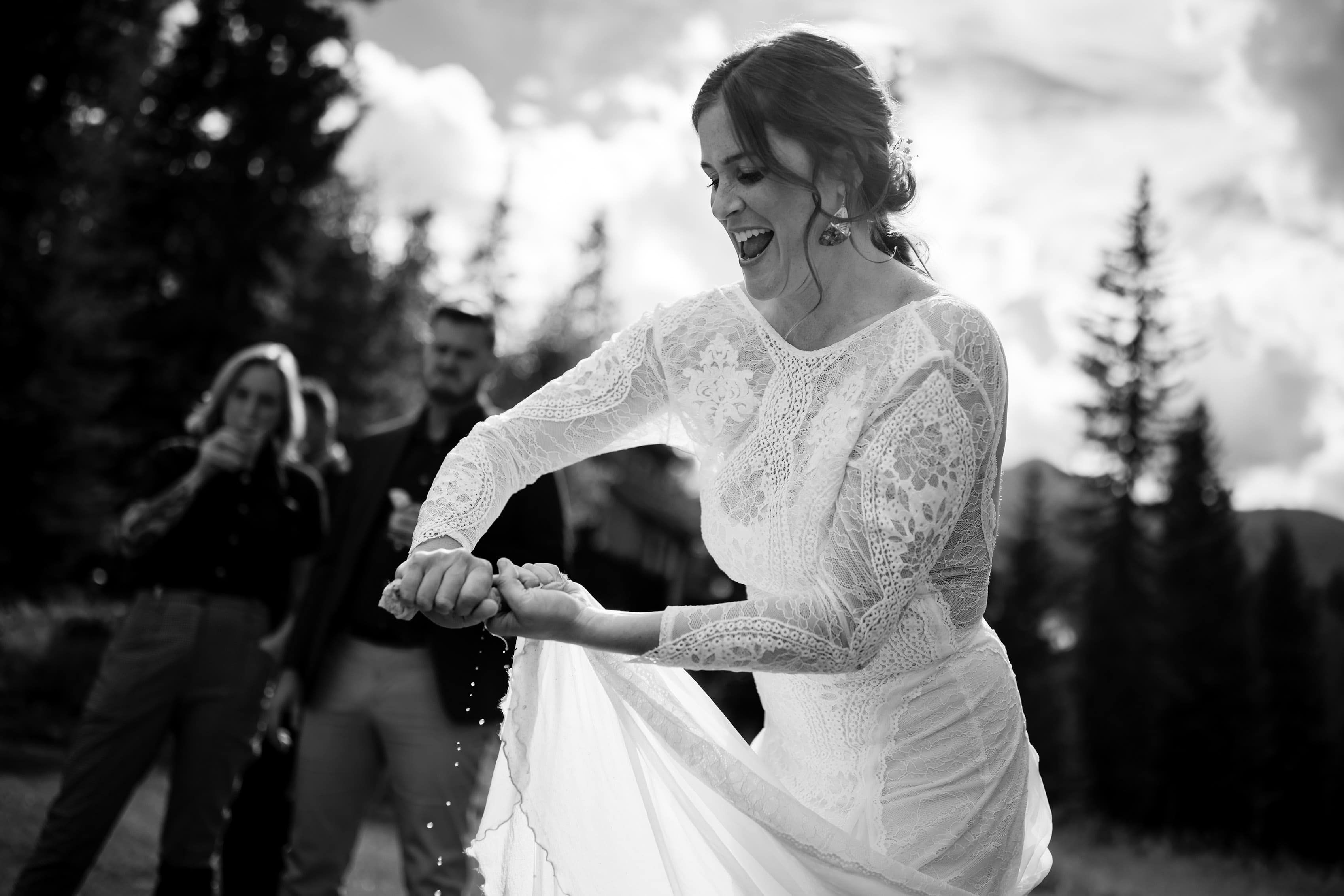 Cait wrings water out of her wedding dress
