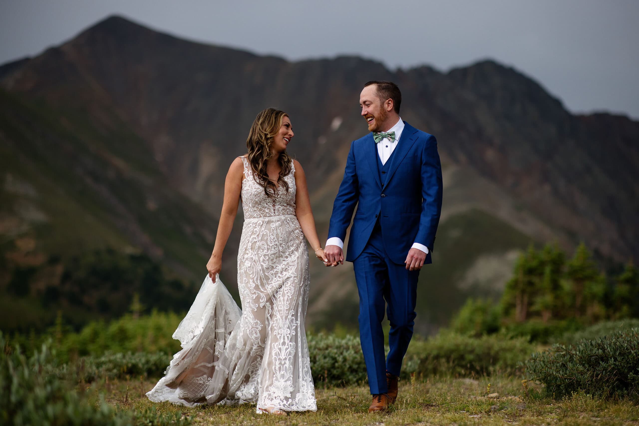 Caitlin and Gavin walk together on Loveland Pass during their wedding day