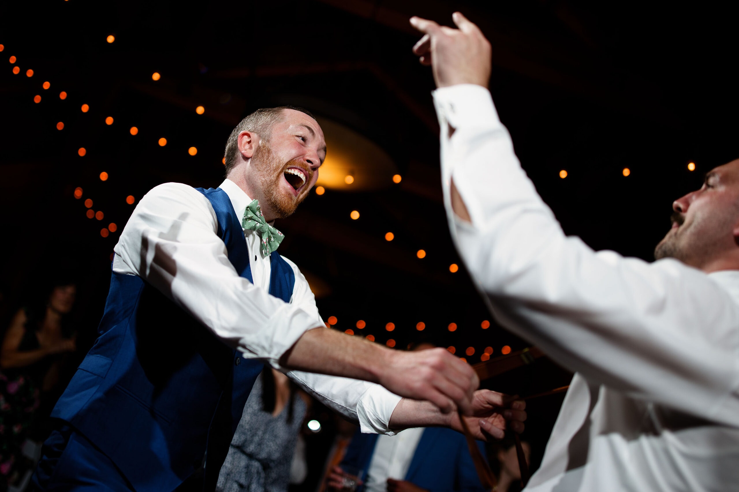 Guests dance during Caitlin and Gavin’s wedding at Black Mountain Lodge