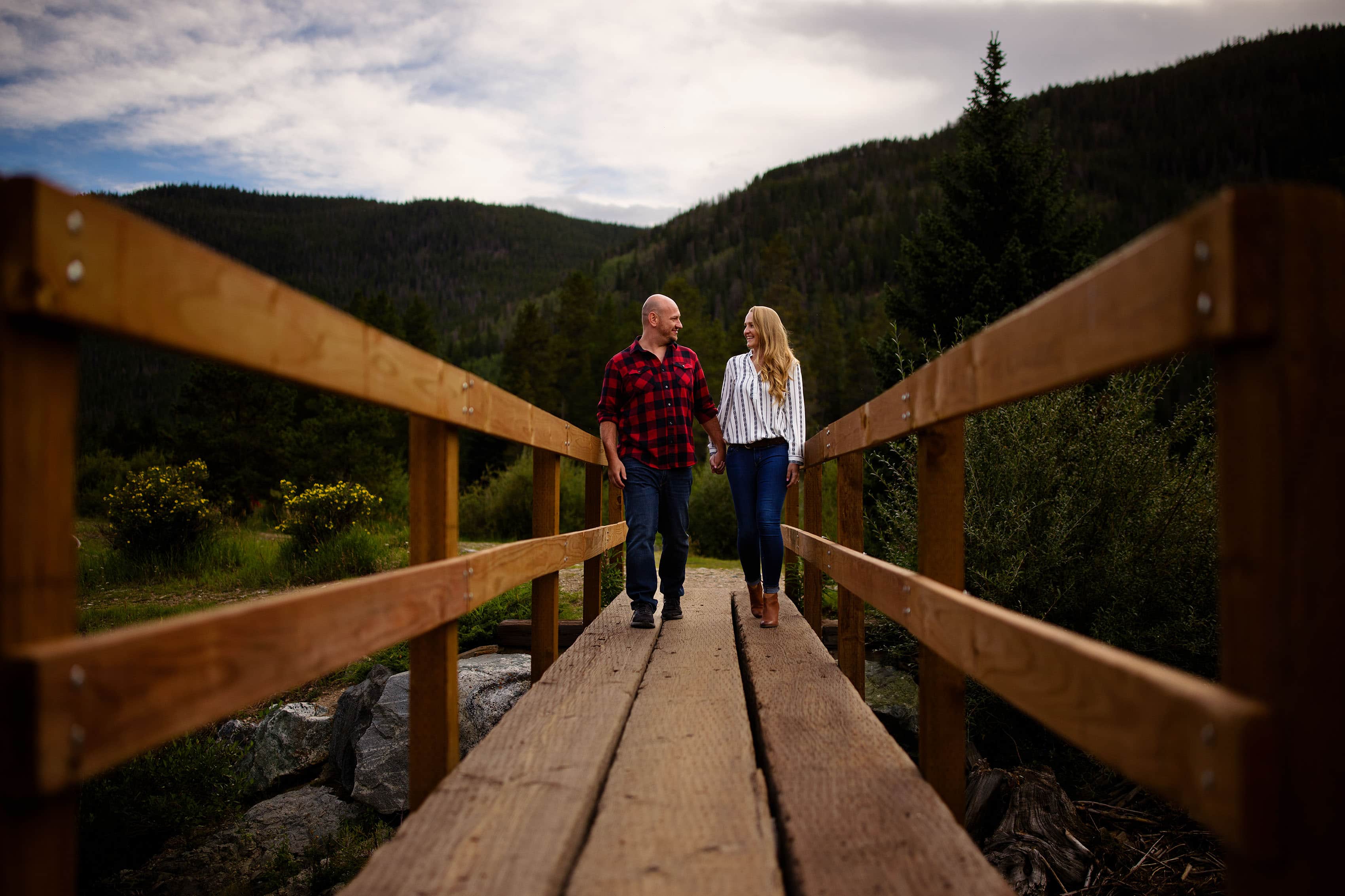 A couple walks on a bridge at Officers Gulch