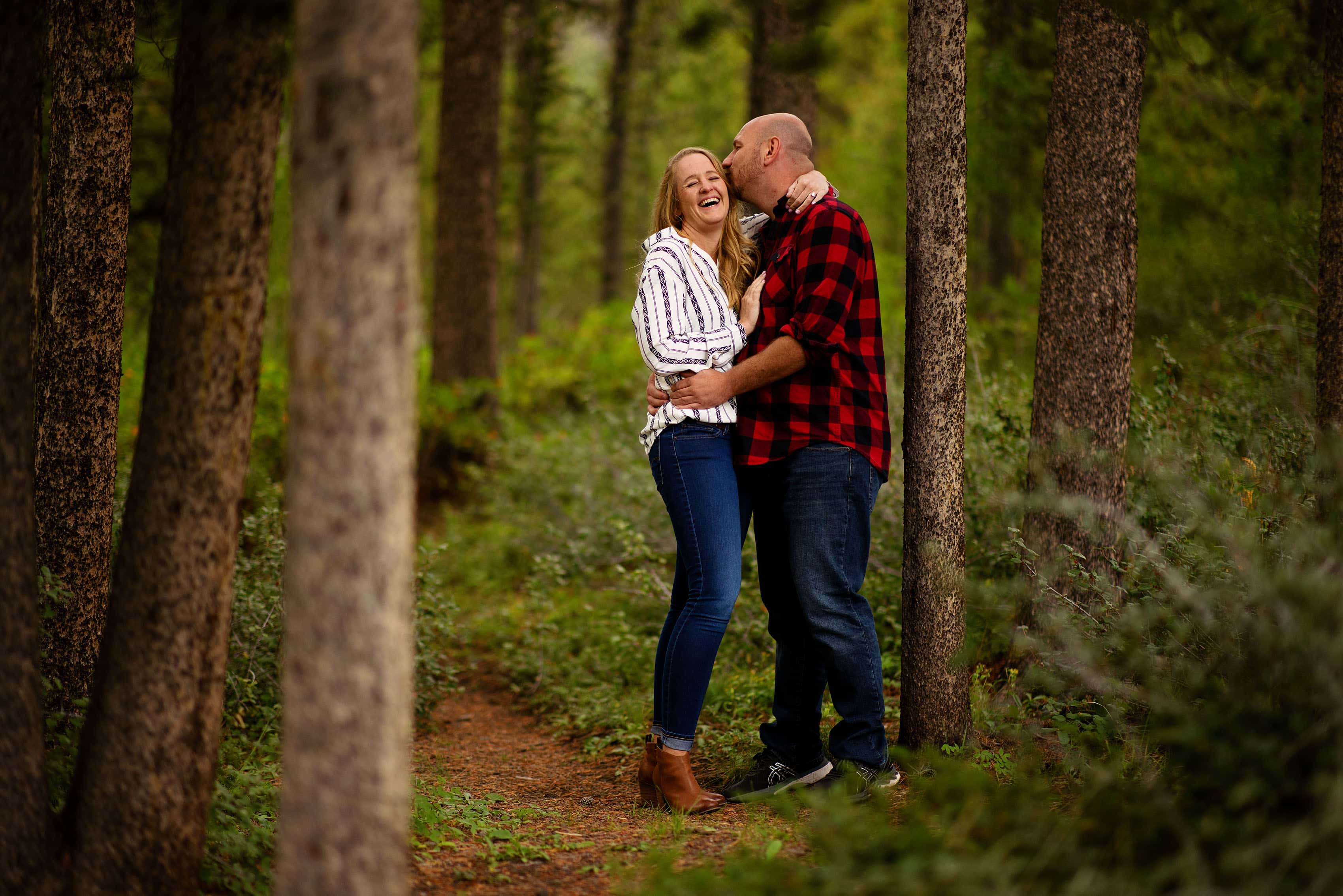 A couple share a laugh together in the woods in Frisco, Colorado