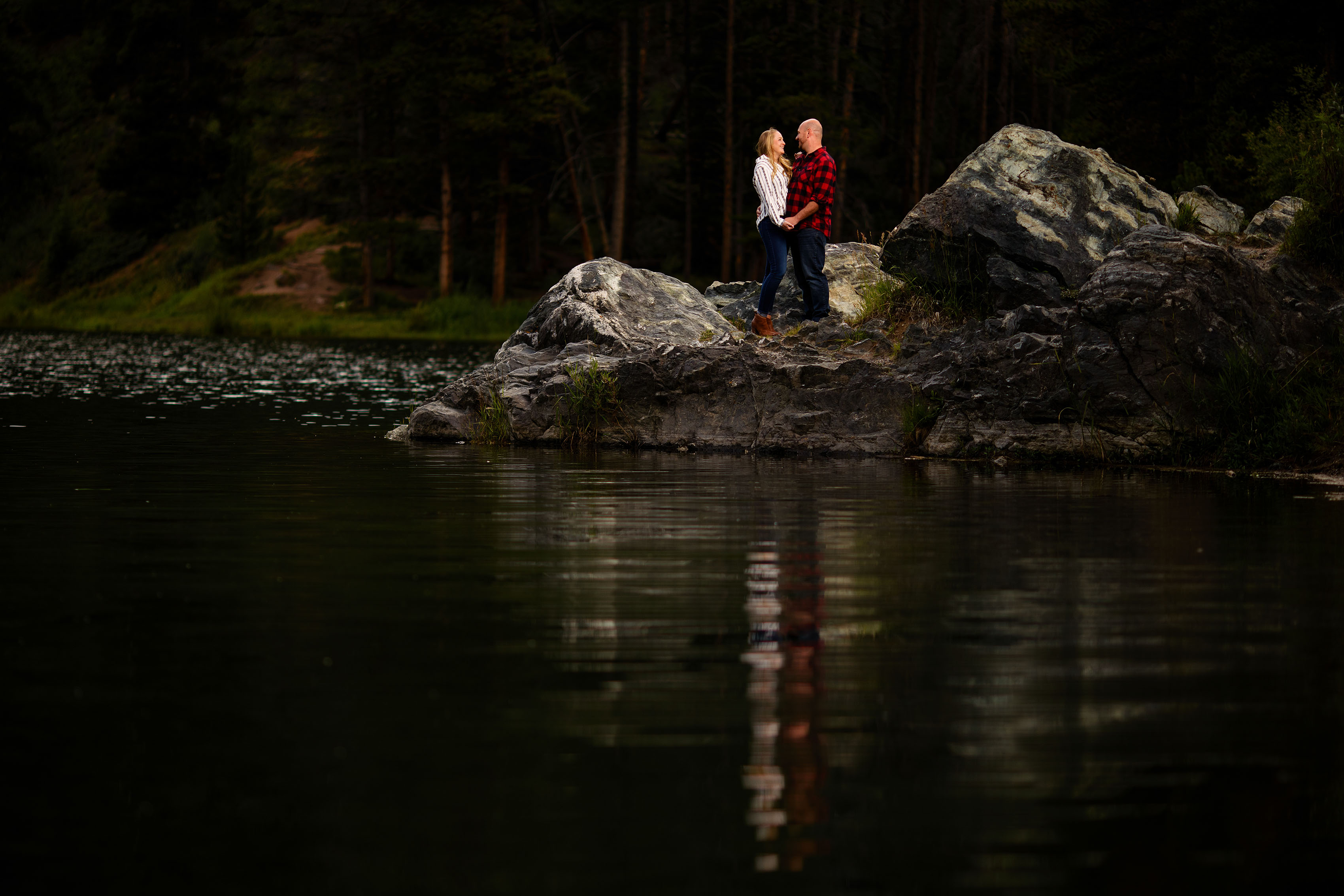 Cassy and David pose on a rock formation at Officers Gulch in Frisco during their engagement