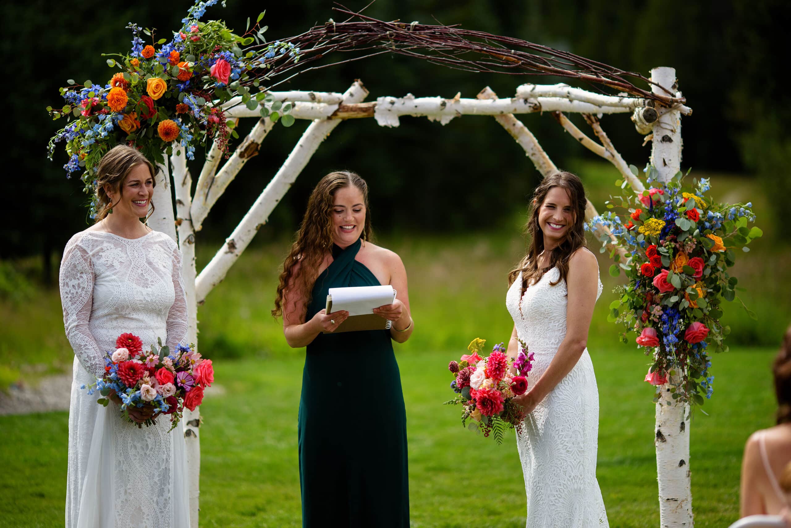 The brides smile during their ceremony at Breckenridge Nordic Center