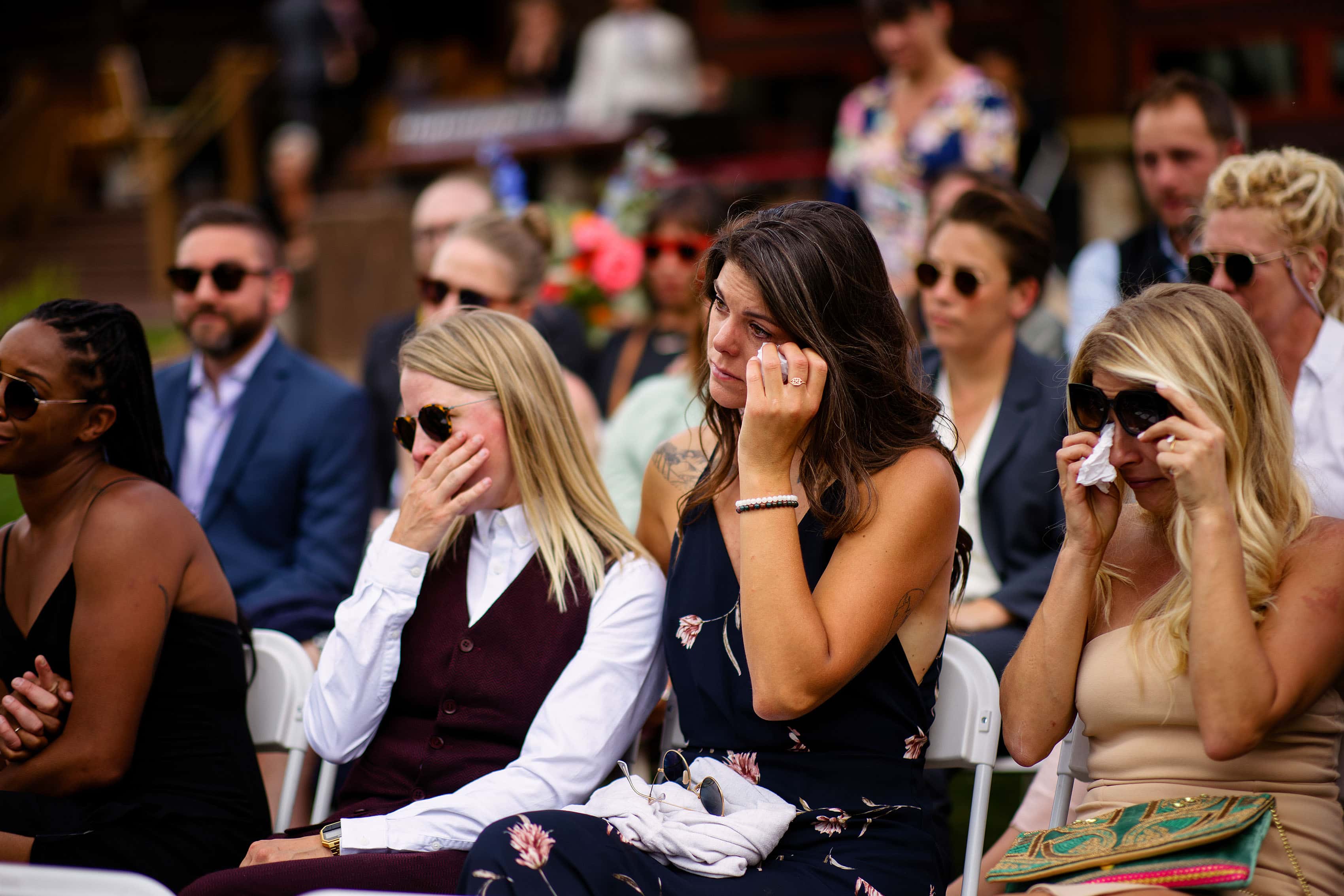 Guests ipe away tears during Anna and Cait’s ceremony at Breckenridge Nordic Center