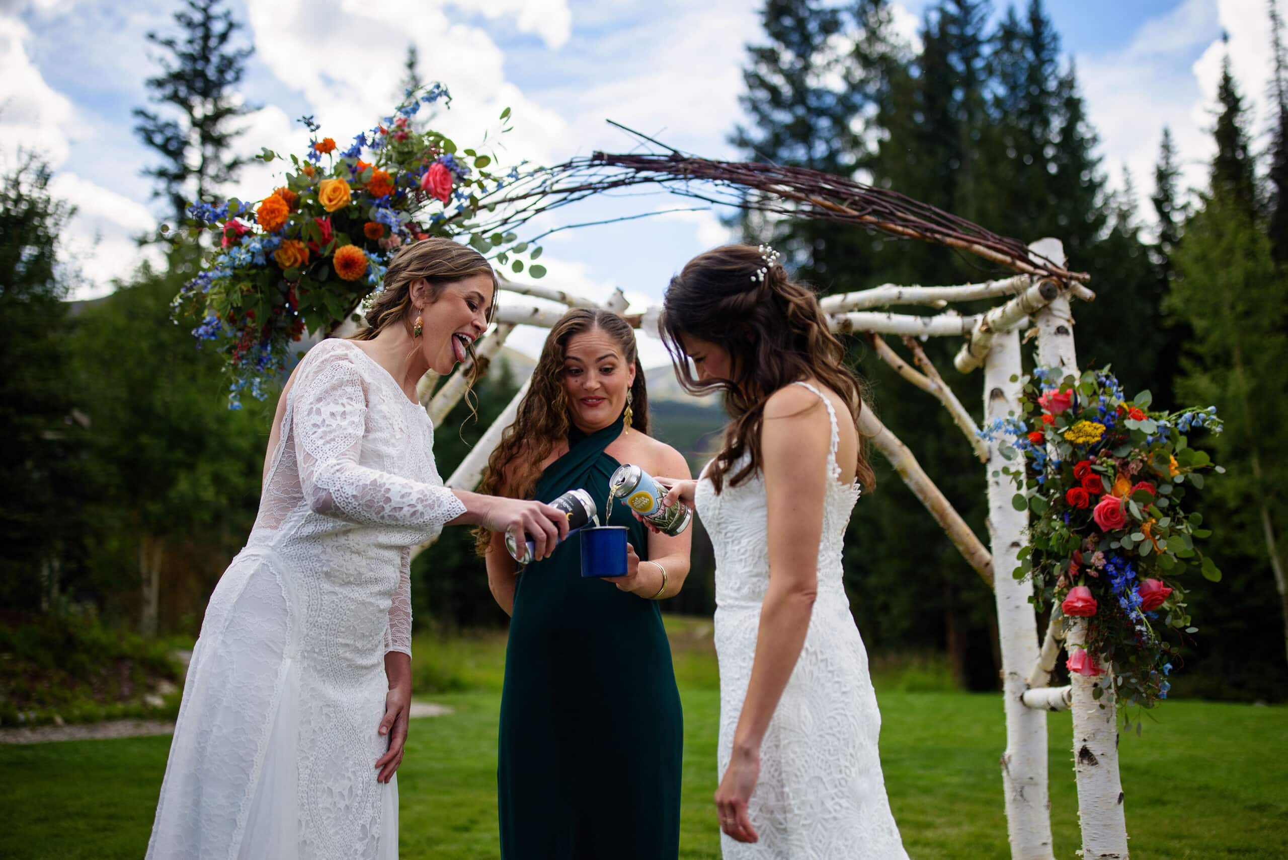 The brides pour beer into a shared cup during their ceremony