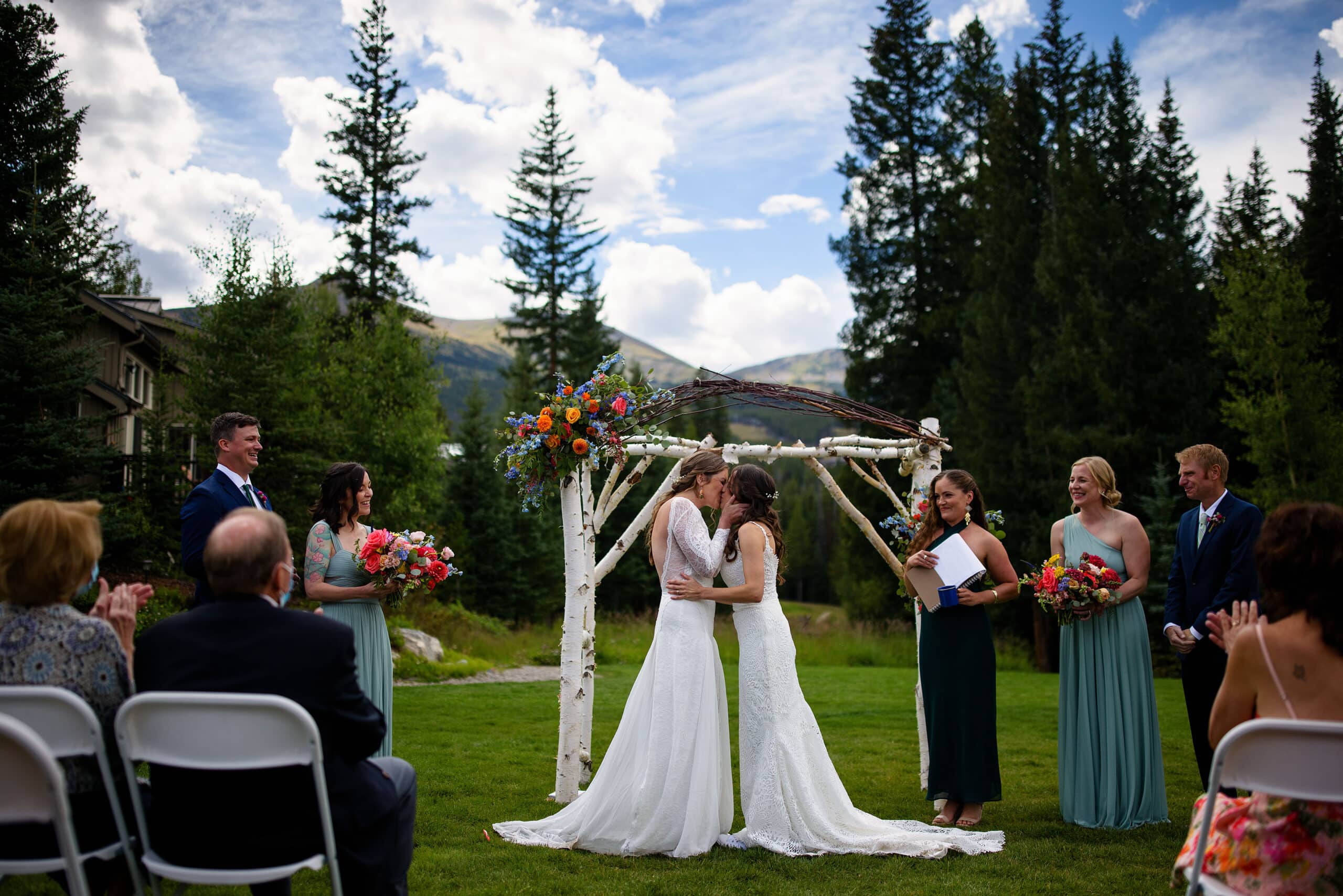 The brides share their first kiss during their ceremony at Breckenridge Nordic Center