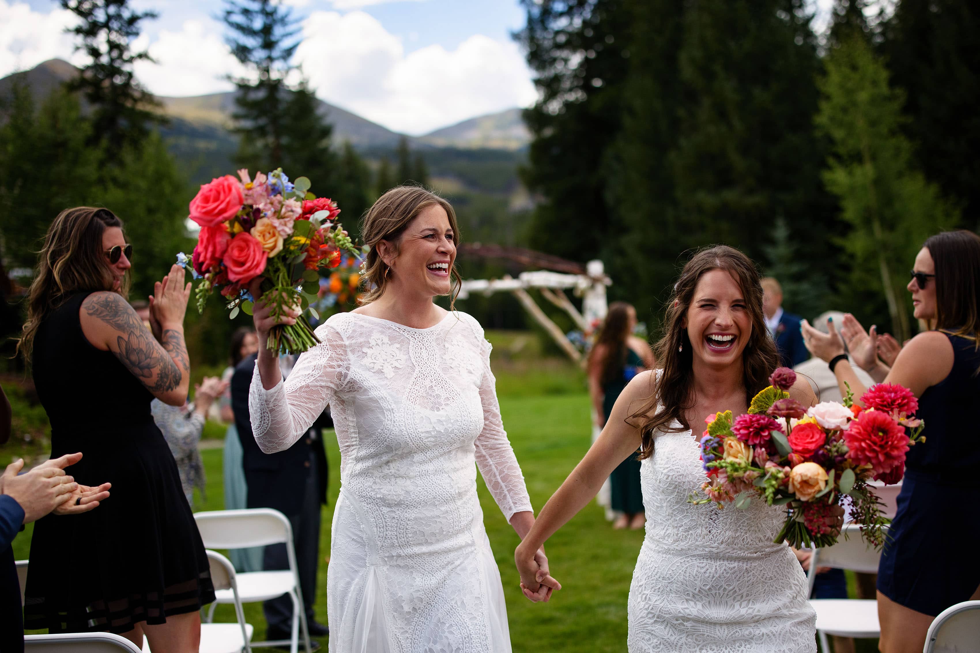 Cait and Anna celebrate as they walk down the aisle