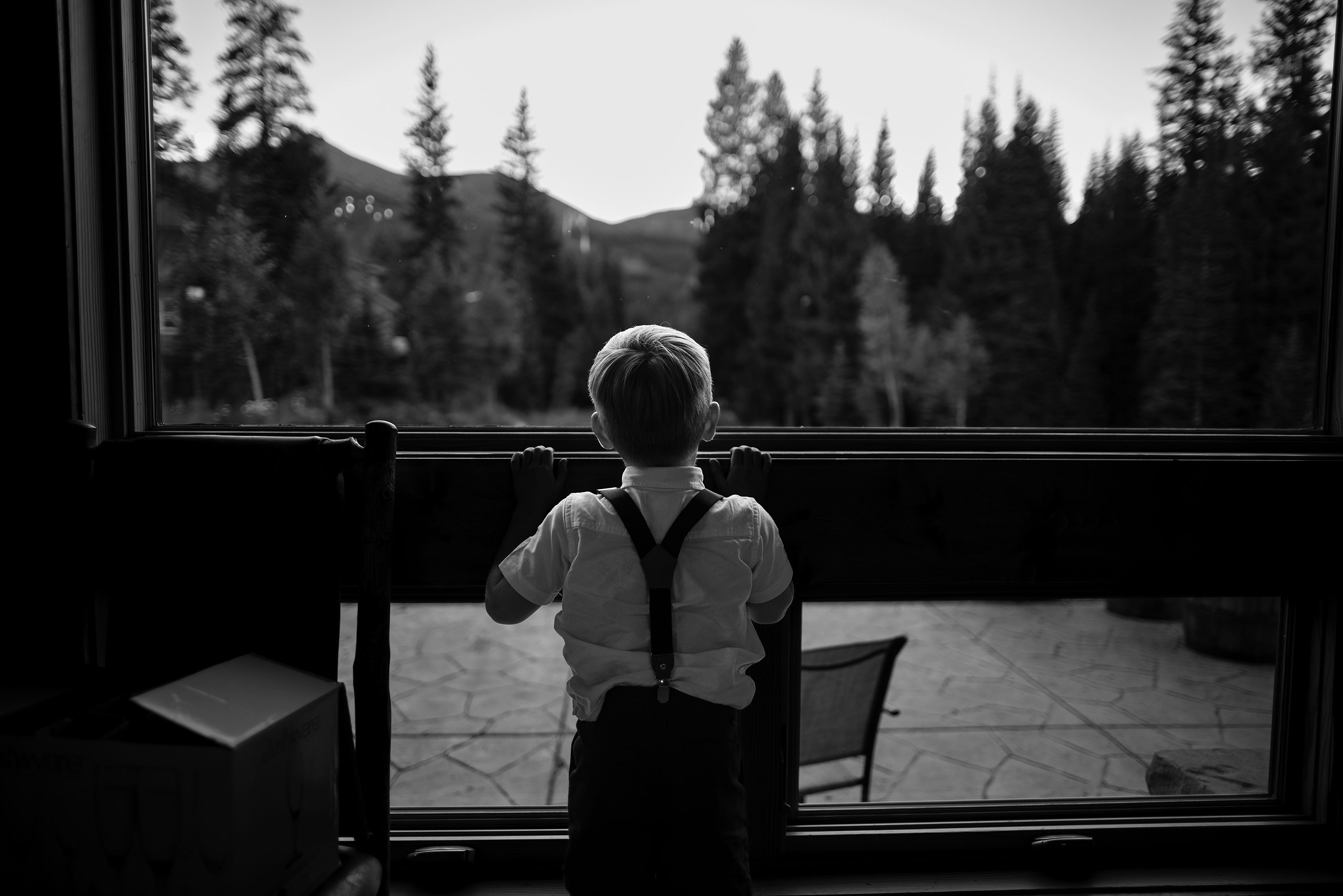 A young boy looks out the window