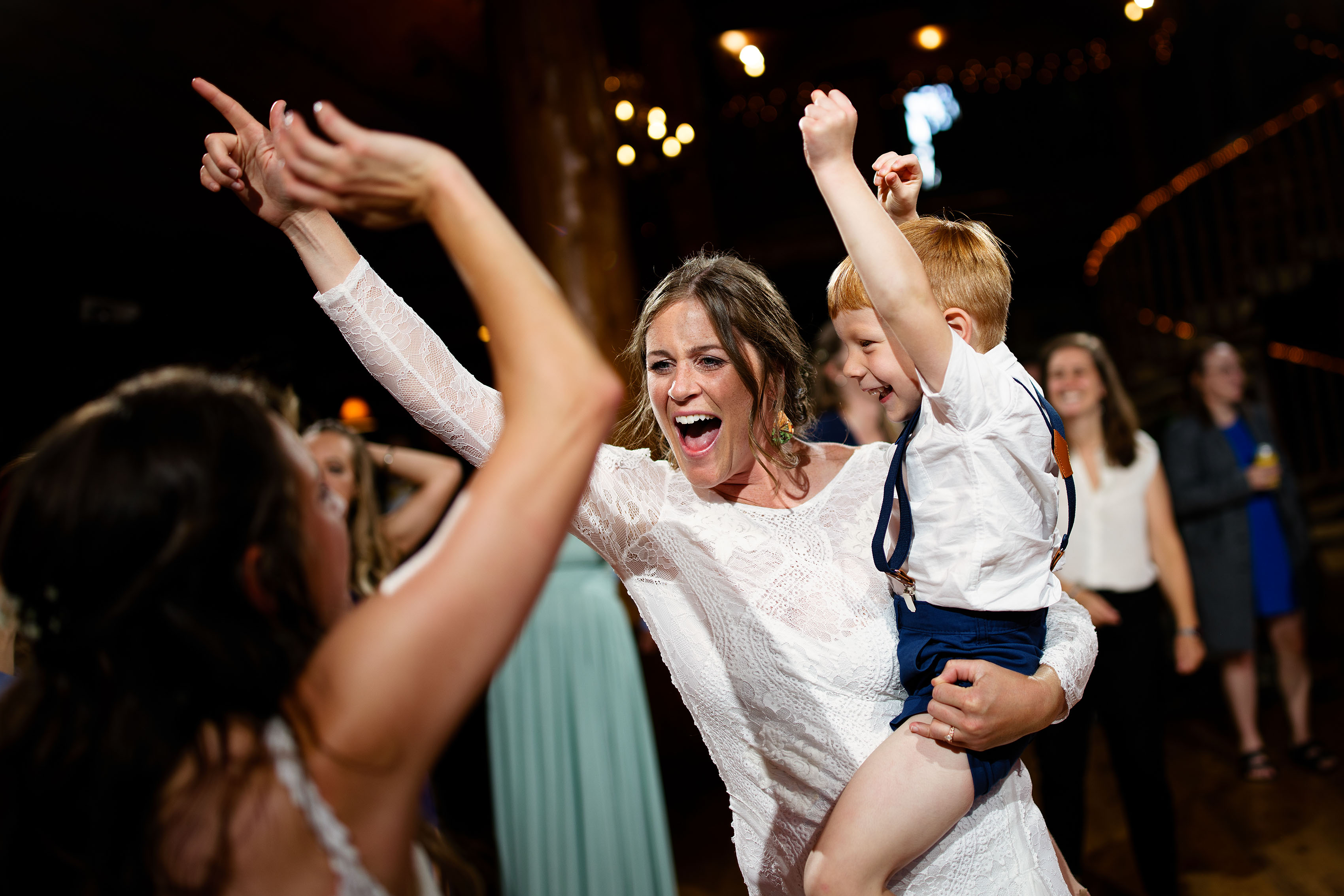 Guests dance together during a wedding reception at Breckenridge Nordic Center
