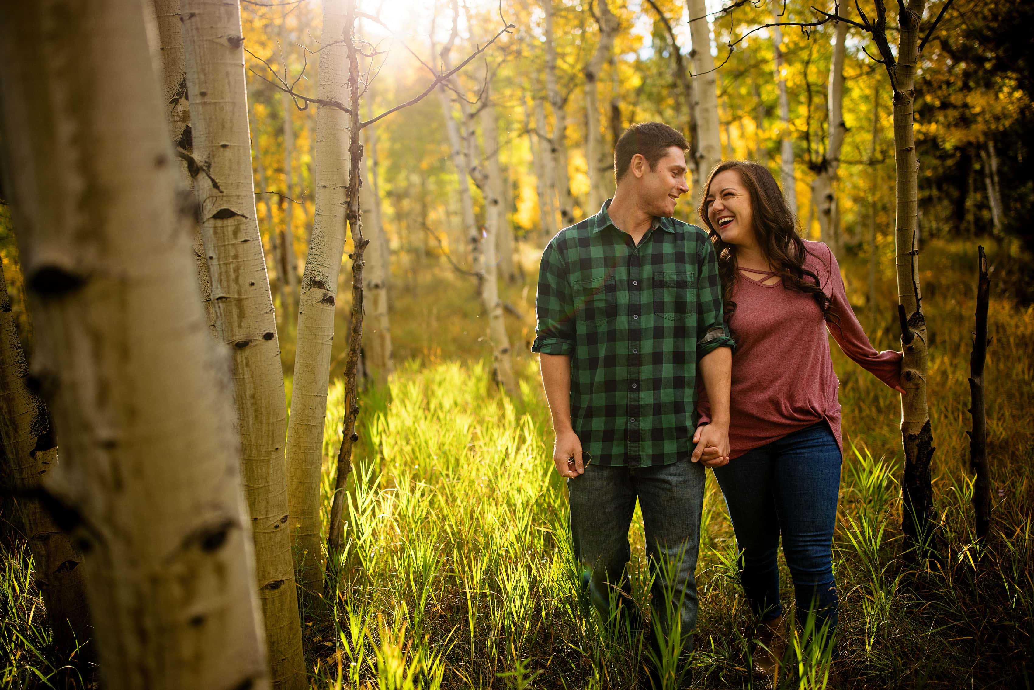 A couple walks in an aspen grove in Frisco, Colorado