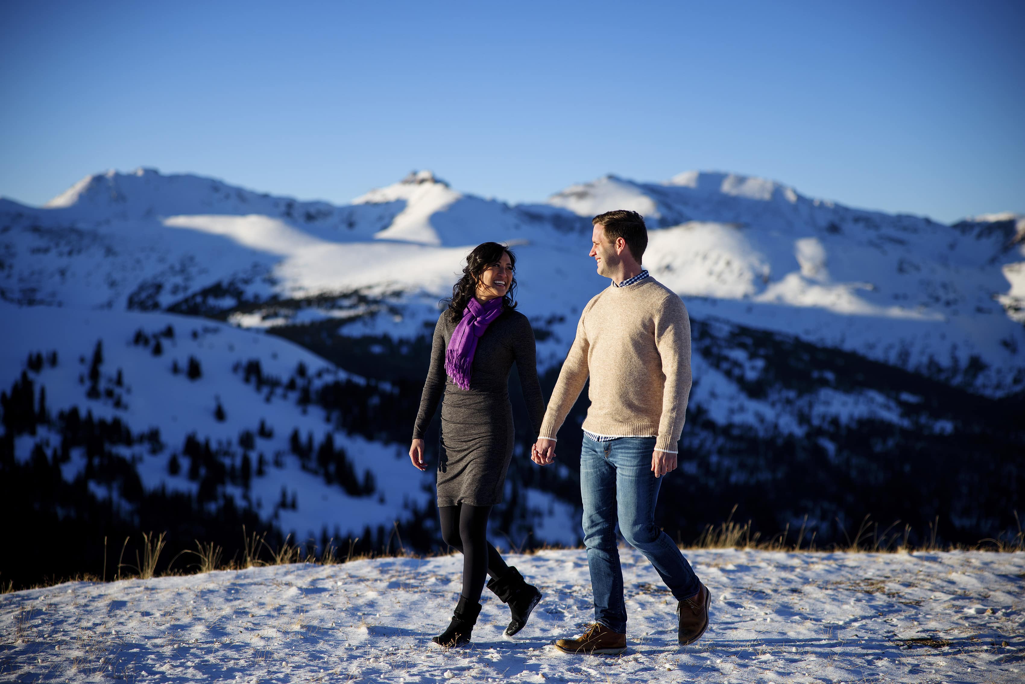 A couple walk together holding hands on Loveland Pass during the winter
