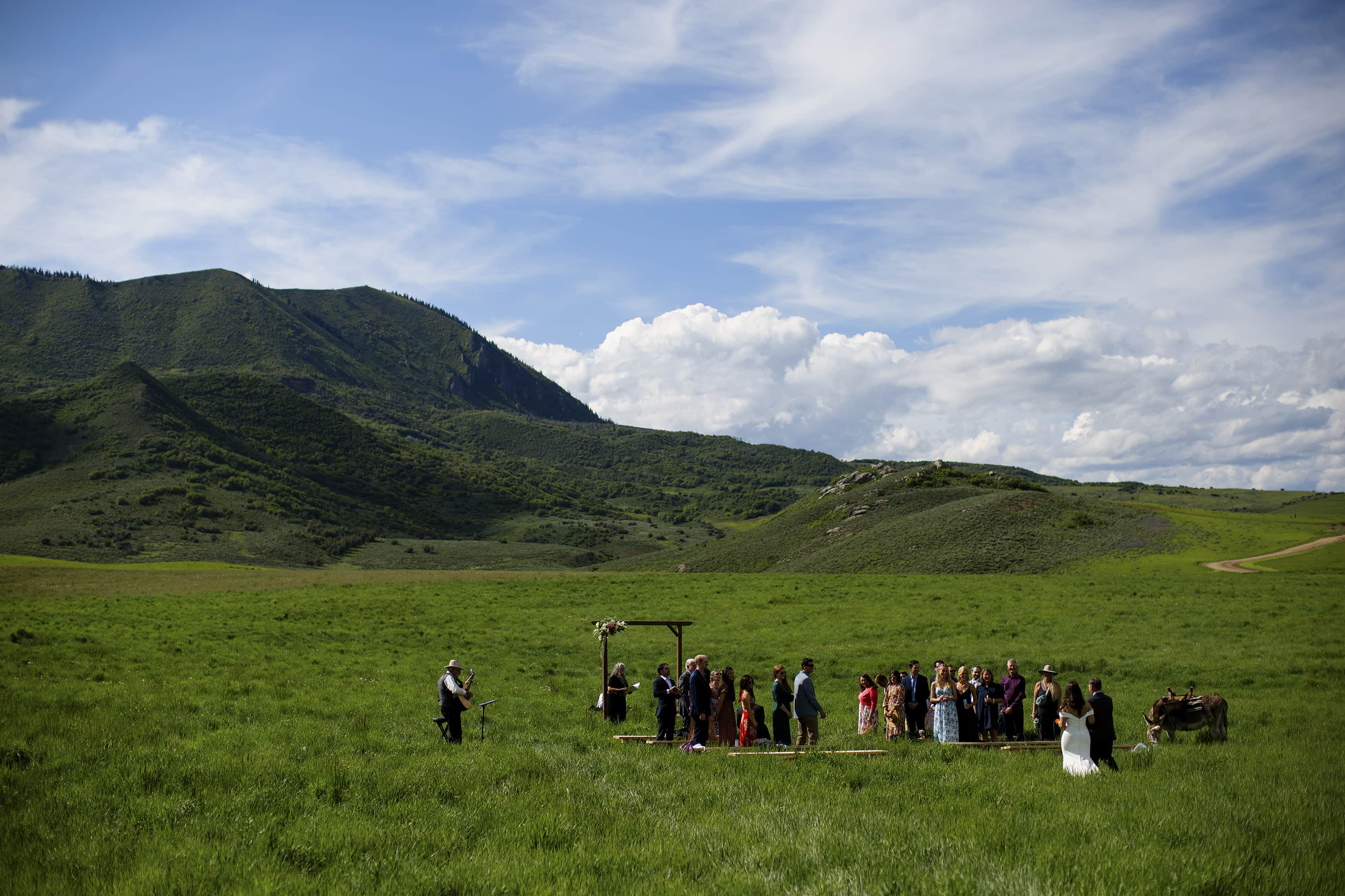 The bride and her father walk down the aisle to the ceremony near Elk Mountain in Steamboat Springs