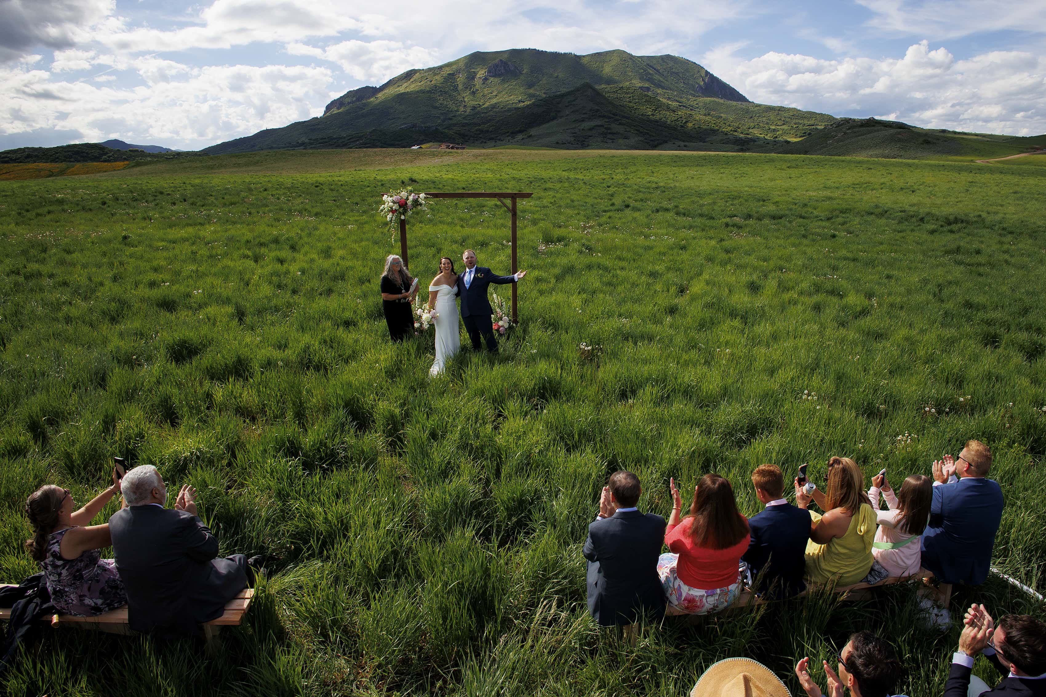The newlyweds celebrate at the end of their ceremony near Elk Mountain in Steamboat Springs for their micro wedding