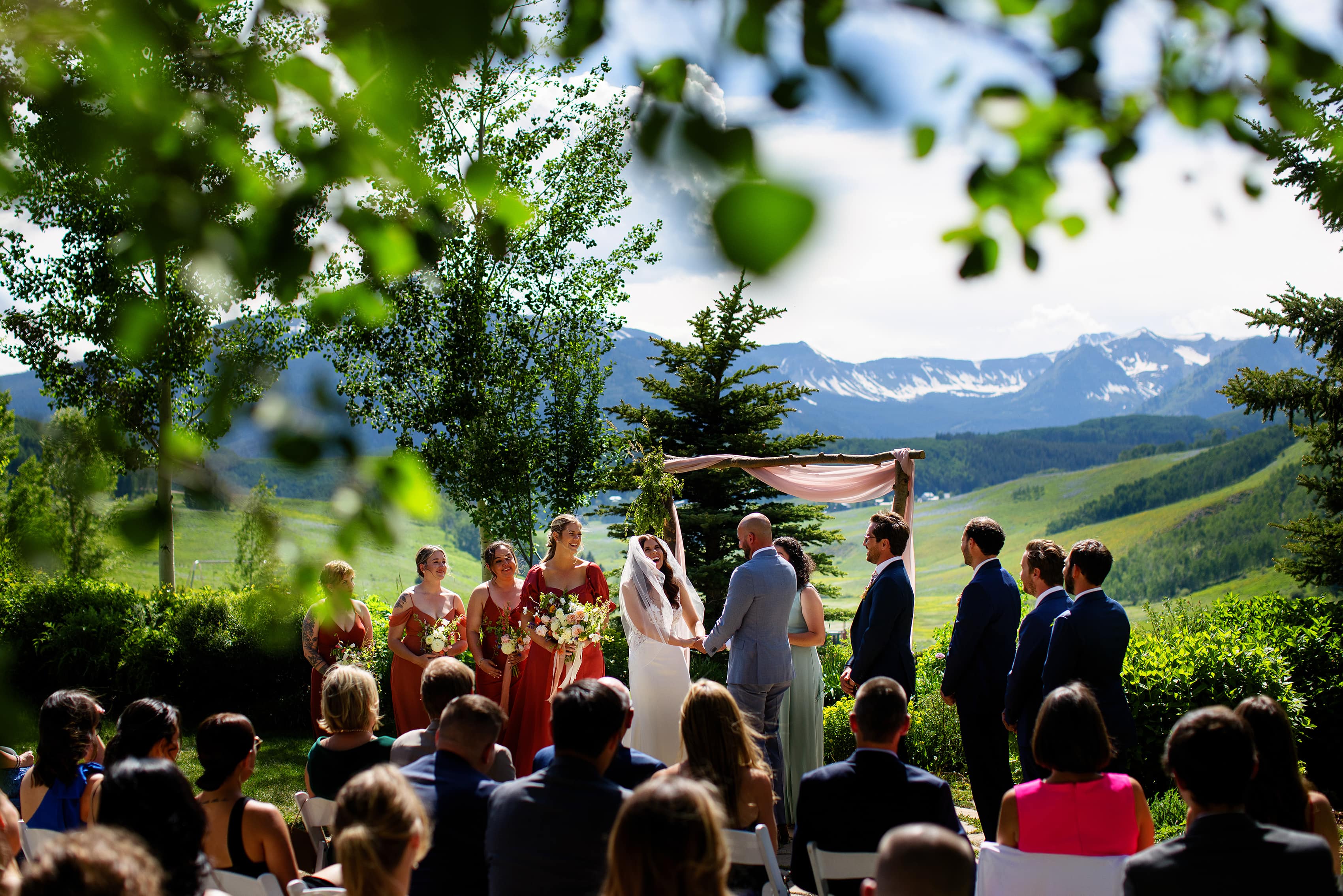 The bride laughs during her wedding ceremony in Crested Butte