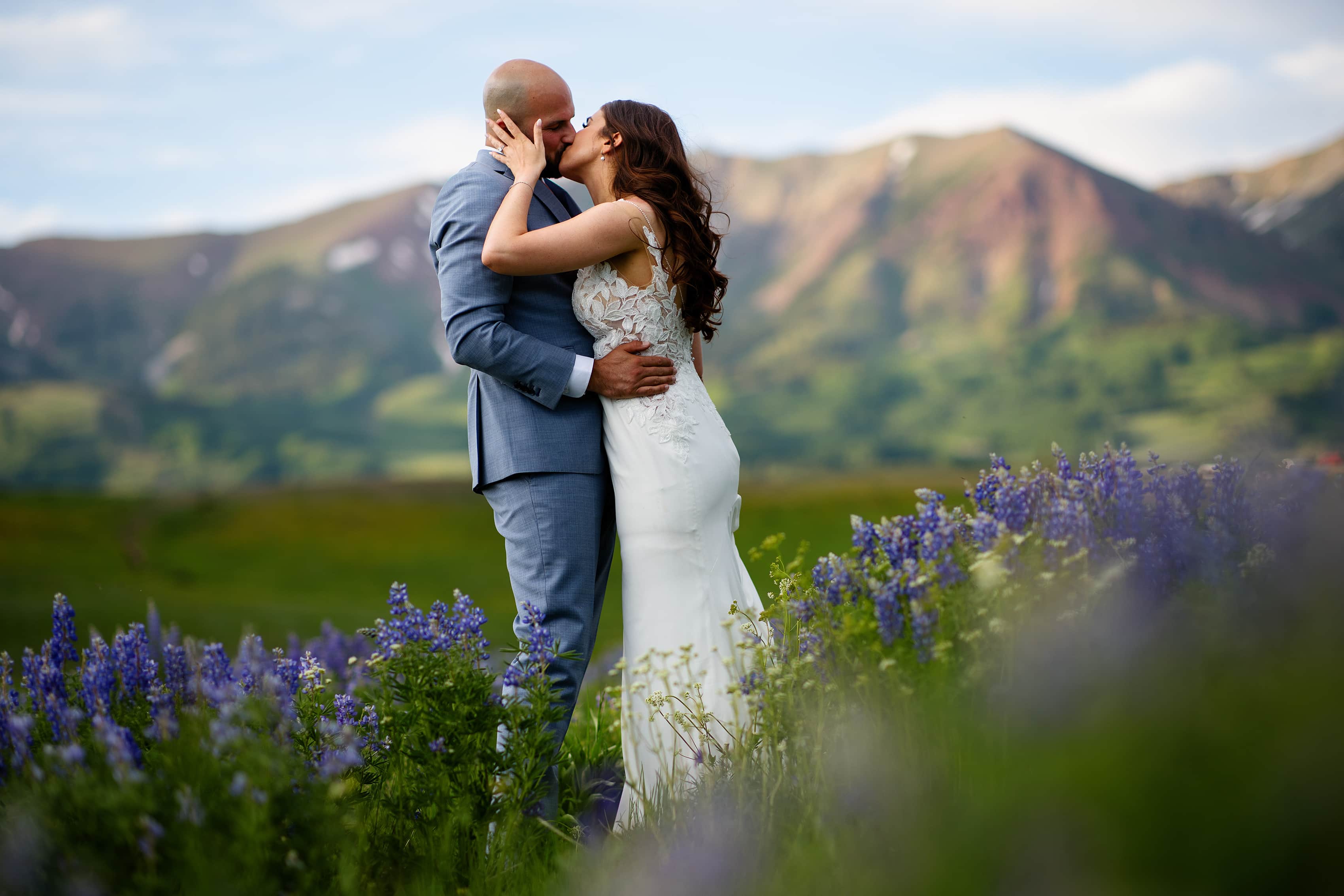 Michael and Sarah share a kiss in a field of wildflowers
