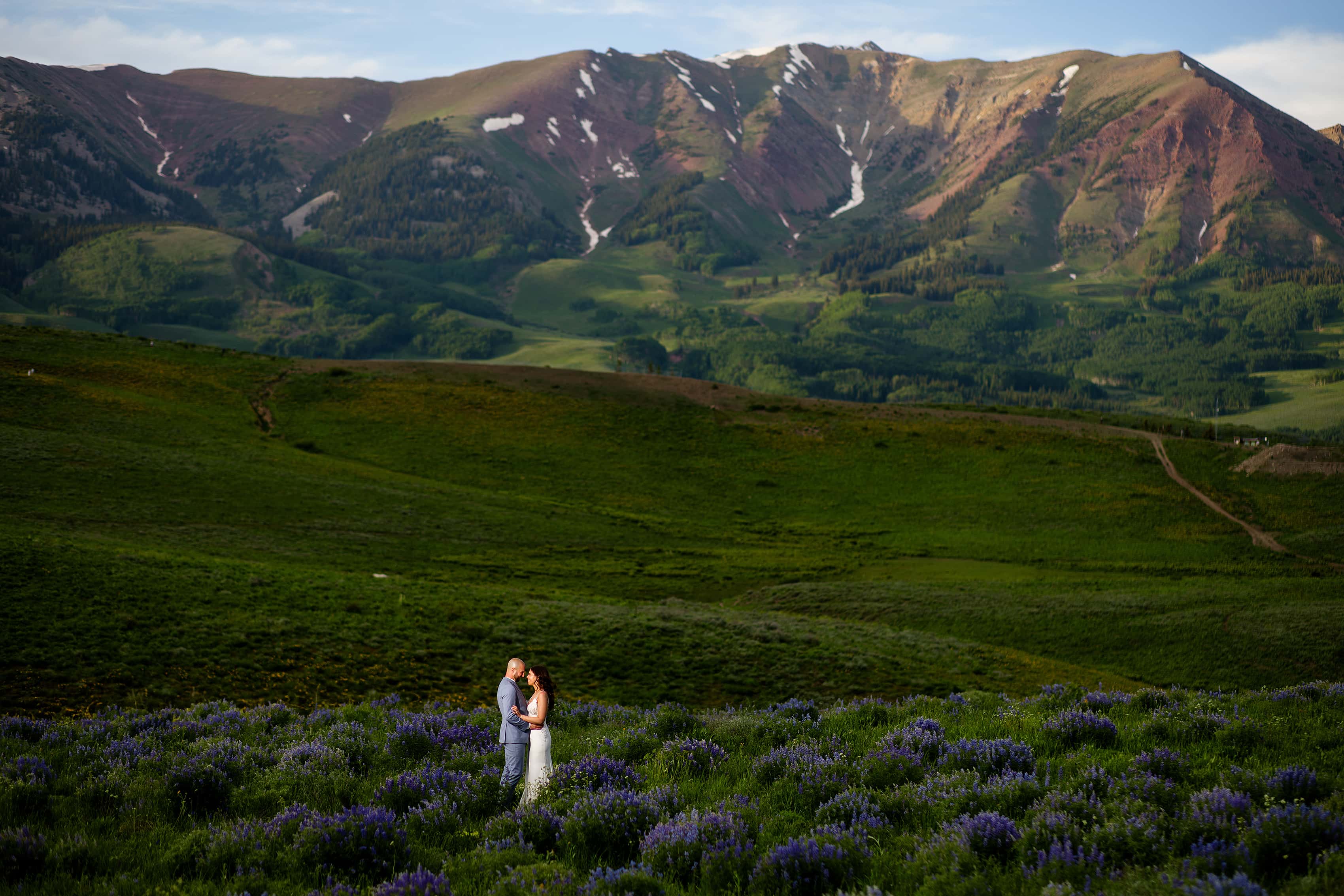 The bride and groom pose during their summer wedding day in Crested Butte