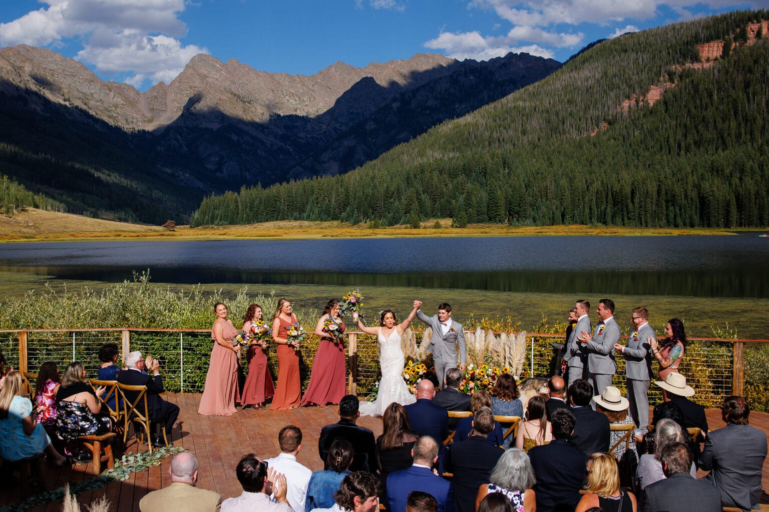 A couple celebrates in front of guests during their wedding ceremony at Piney River Ranch