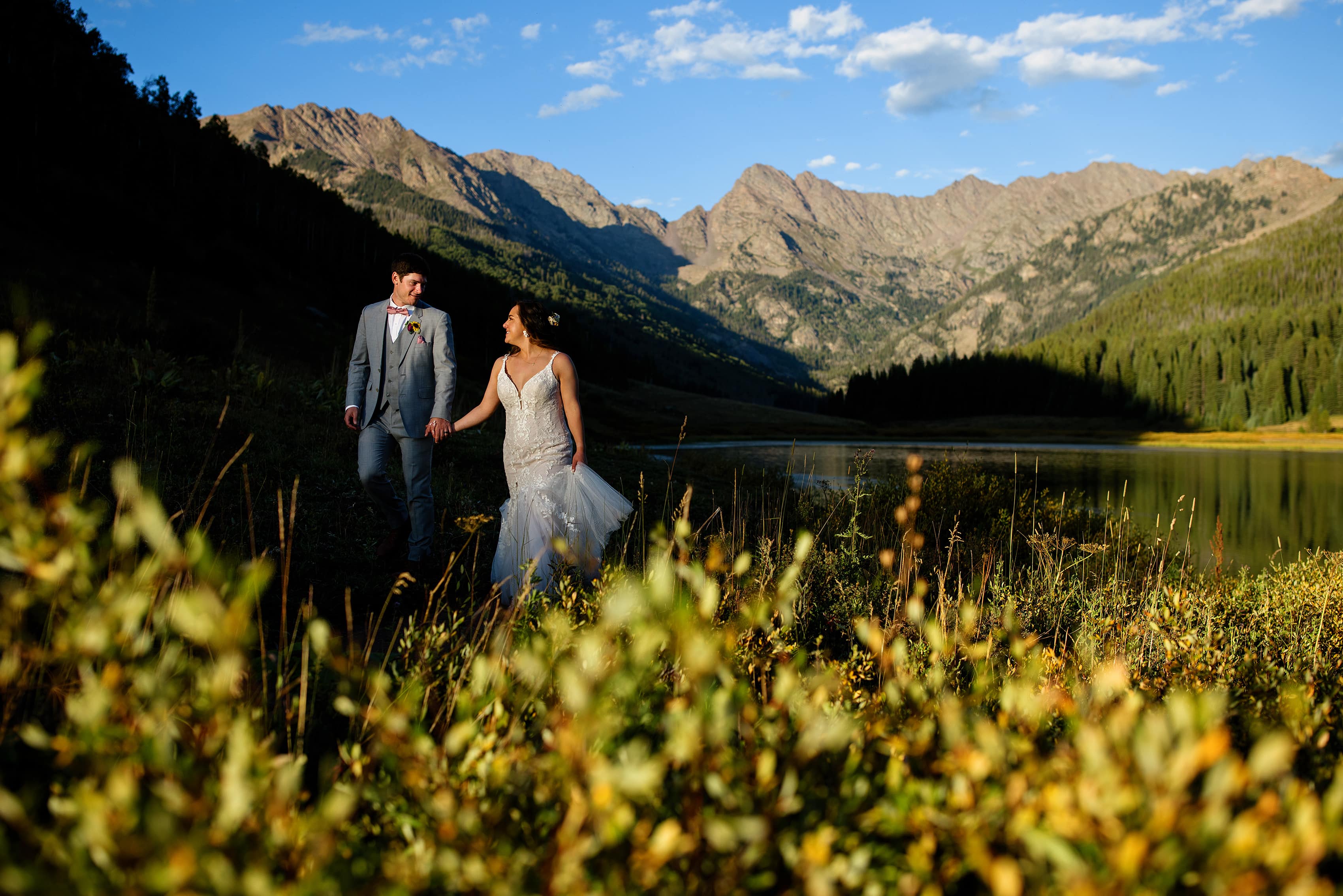 Danielle and Gabe walk along the path near Piney Lake during their wedding day